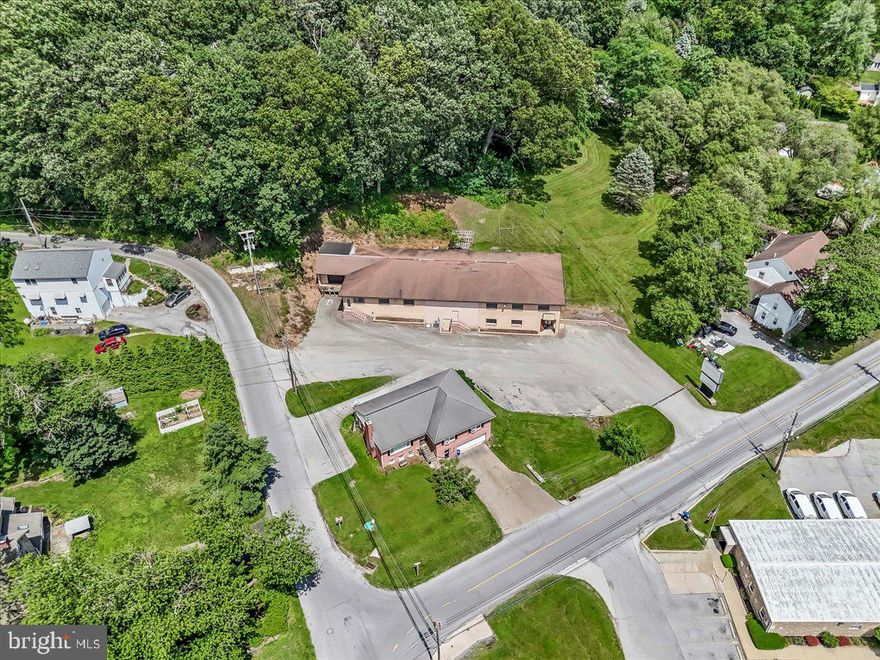 Flexible commercial opportunity with over 9000 square feet on two levels, parking lot and 3-bedroom house.
Zoning requires municipal approval of commercial use. House is currently rented.