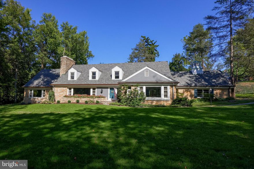 Nestled in a serene, park-like setting with a stream winding through the property, this sprawling home sits on a rare double lot totaling 1.3 acres in the sought-after York Suburban School District. Located just minutes from the Country Club of York, Regents’ Glen, York Hospital, York College, York Country Day School, and the York County Heritage Rail Trail, this home offers both privacy and convenience. The main level features a bright, open layout anchored by a thoughtfully designed floor plan with no wasted space, abundant built-ins, and generous closet storage throughout. The primary bedroom suite and a guest bedroom with a full bath are conveniently located on the first floor, along with a designated office/guest room, additional guest baths, and a powder room. The family room showcases exposed wood beams, a cozy wood-burning fireplace, and a large picture window framing lush green views. The upgraded kitchen blends modern convenience with the home’s original charm, complete with a gas six-burner stove and an eat-in area. Enjoy peaceful views from nearly every room or relax on the screened-in porch. The upper level offers three spacious bedrooms with ample storage and two full baths . The lower level provides flexible space for entertaining or additional living, featuring a family room with a wet bar. A truly unique property offering timeless character, functional design, and a tranquil setting rarely found.