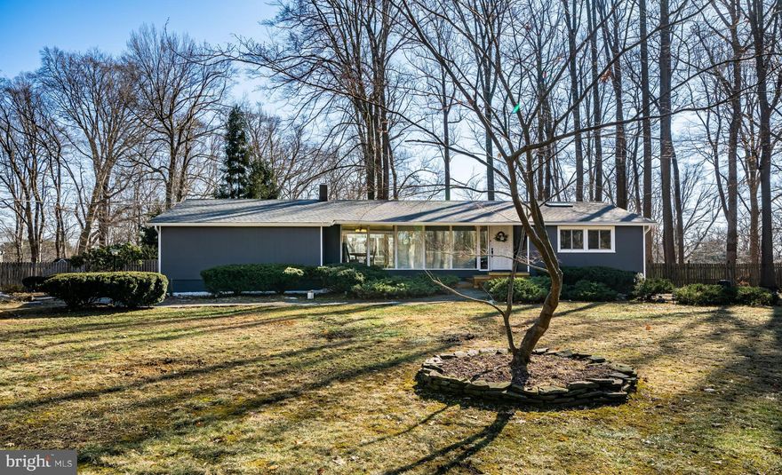 Nestled on a quiet drive in an exclusive 2 street cul-de-sac community of secluded lots set on just under 3/4 acres of gently rolling land, mature trees & beautiful landscaping attracting a diverse blend of wildlife, deer and birds, makes it feel as if you are strolling through a park with the best nature has to offer than a neighborhood. This is where you’ll find this rarely offered ranch home boasting just under 2700 sq feet of finished living space overlooking trees and woodlands where nature prevails. Here you’ll be greeted by a stone walkway and welcoming porch with stone and wood beamed steps and the calming water fountain just to the left of the homes entry. You’ll be impressed by the refinished hardwoods (Jan 2022) as you enter the very spacious great room accentuated by soaring 3-beamed cathedral ceilings highlighted with pendant ceiling lighting and a wall of windows which includes a double wide glass slider door that opens to a deck which spans the length of the home overlooking a private and serene rear yard and beyond. There are a great many windows and glass doors throughout the home offering fabulous views and a captivating connect to the outdoors that is memorable in any season. This 4 bedroom, 2 full bath home is loaded with updates and improvements of more than $115,000 in recent renovations including a decorators touch with a palate of warm colors found throughout, such as new vinyl replacement windows, new roof and (2) new sky lights (July 2021), all new roof gutters & soffits (Jan 2022), oil furnace (Oct 2020). Full list see documents! Dining area open to the great room provides ample space for hosting large holiday dinners for extended family & friends. The well-equipped kitchen features a breakfast room with two large bay windows, vaulted ceilings w/skylight, granite countertops, an attractive travertine stone backsplash, under cabinet lighting, SS fridge, range hood w/exhaust, pantry, ceramic tiled flooring & 3 doors offering access to rear deck, driveway & attached 2 car garage w/storage loft. A secluded study / home office is strategically located offering custom built-ins, casement windows plus a double door closet. Opposite the office you’ll find the homes main bedroom with (2) pocket door entries to the room and offers a double wide closet, an additional closet and double wide glass slider doors w/access to the rear deck and access to the wood paneled full bath with fully tiled new frameless glass, multi head shower with shower seat, new commode (Nov 2021), updated vanity lighting, plumbing fixtures & ceramic tiled floor. The fully finished lower level offers an additional 1200+ sq feet of living space walks out to a sprawling stone patio perfect for grilling or entertaining. A large den with refinished hardwoods and (3) built-in bookcases offer access to the patio. There are (3) generously sized bedrooms with casement windows and spacious double wide closets, an updated full ceramic tile surround bathroom plus a huge laundry room with wall cabinetry, folding station, closet and patio access. A fully fenced in shaded rear yard includes a multi-level patio that provides plenty of open space and mature trees, a small fish pond and a stoned path leading to children’s playhouse tucked away in yards near corner. Utility room with painted walls and floor complete the lower level. Just down the road to Historic Doylestown Boroughs array of shops and boutiques, fine selection of eateries, wonderful amenities as its numerous museums, Font Hill Castle, library, several nearby parks including Central Park and trains as well as the Boroughs cultural events & Doylestown CC! Minutes from Doylestown Skatepark and YMCA. Commuters will be delighted with easy access to major commute routes to Princeton NYC and Center City Philadelphia. Located in the highly acclaimed Central Bucks School District. Come see this lovely ranch just a stone’s throw from the borough and start enjoying secluded, county living!