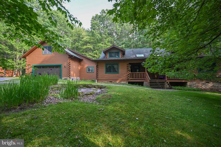 Enjoy the country life and the quaint setting of this 3 bedroom/2 bath Log Home tucked in the woods.  The home offers a front porch and rear decks, heated oversized 2 car garage, mud room connecting garage to house and 2 offices/library areas.  Upon entering you can feel the ambiance of living in a log home.  Home has multiple heat sources:  wood burning store,  propane standing stove and electric.  The open floor plan makes for ease and great entertainment areas connecting the living/kitchen/dining areas.  Sit back and relax in this charming log home while enjoy the many outdoor sitting areas with the birds signing and look out upon nature's setting.