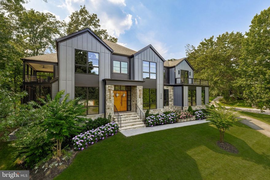 Crafted by Morbill & Associates in 2023 and set on a wooded .48-acre homesite in the Langley High School pyramid, this residence offers a rare combination of architectural refinement and retreat-style living seldom found among newer construction homes in McLean. Multiple covered balconies, a screened porch with fireplace and swing overlooking the woodland, and a rare four-car garage create privacy and flexibility, while nearly 8,000 square feet of thoughtfully designed interiors provide elegant yet comfortable everyday living graced with smart-home technology minutes from downtown McLean.

The entrance makes a striking first impression with mahogany double doors framed by natural stone on both the exterior and interior, opening to a welcoming foyer with a clear sightline through the main living spaces to oversized rear sliding doors and the wooded backyard beyond.

Inside, refined craftsmanship and livability exist effortlessly together alongside integrated smart-home technology. Multiple gathering spaces across three finished levels support entertaining, quiet retreat, or remote work.

A front office with limestone fireplace and furniture-grade built-ins supports work and study near the main entry.

At the center of the home, the chef’s kitchen features a full Miele appliance suite, paneled refrigerator and freezer columns, double dishwashers, double wall ovens, an integrated microwave, a waterfall island, custom cabinetry, exposed beam detailing, and a custom range hood with pot filler. An adjacent walk-in pantry positioned behind the appliance wall is sized for conversion to a secondary kitchen. A separate butler’s pantry with beverage cooler and sink connects the kitchen to the dining room, while a rear service hall provides access to a second powder room, mudroom with built-ins, garage entry, a large utility storage closet, and a secondary staircase to the upper level.

Throughout the home, six gas fireplaces, wide-plank European oak flooring, stone accents, and designer lighting from makers such as Visual Comfort and Modern Forms reinforce Morbill’s signature craftsmanship.

Outdoor living includes a screened porch with fireplace and swing overlooking the woodland, wraparound balconies on multiple levels, and a private wrap-around terrace off the primary suite overlooking the surrounding landscape and creating elevated treehouse-like outdoor retreats.

The primary suite offers vaulted ceilings, fireplace, wrap-around terrace access, dual custom walk-in closets, heated marble bathroom floors, soaking tub, floating vanities, and a glass-enclosed shower designed as a spa retreat. Three additional en-suite bedrooms, a central loft with fireplace and balcony, and a spacious laundry room with sink complete the upper level.

The walk-up lower level includes a recreation area with fireplace, wet bar, glass-front wine closet, fitness studio with natural light, flex room, abundant storage, and a separately situated en-suite guest suite ideal for multigenerational living.

Smart-home infrastructure includes whole-home audio, CAT-6 wiring, security cameras, app-controlled lighting and garage systems, EV-charging capability, and four-zone HVAC. The four-car garage offers ceiling height suitable for a lift.

The grounds combine mature woodland privacy with usable level lawn areas and space for a future pool area, sport court, play area, and expanded outdoor living while preserving natural screening rarely found near town.

Ideally located steps from McLean Central Park and downtown McLean and a short walk to Churchill Road Elementary School, with convenient access to Tysons Corner, Metro service, and Washington, DC.

A newer construction residence combining the craftsmanship of one of McLean’s premier builders with privacy, flexibility, and everyday convenience.