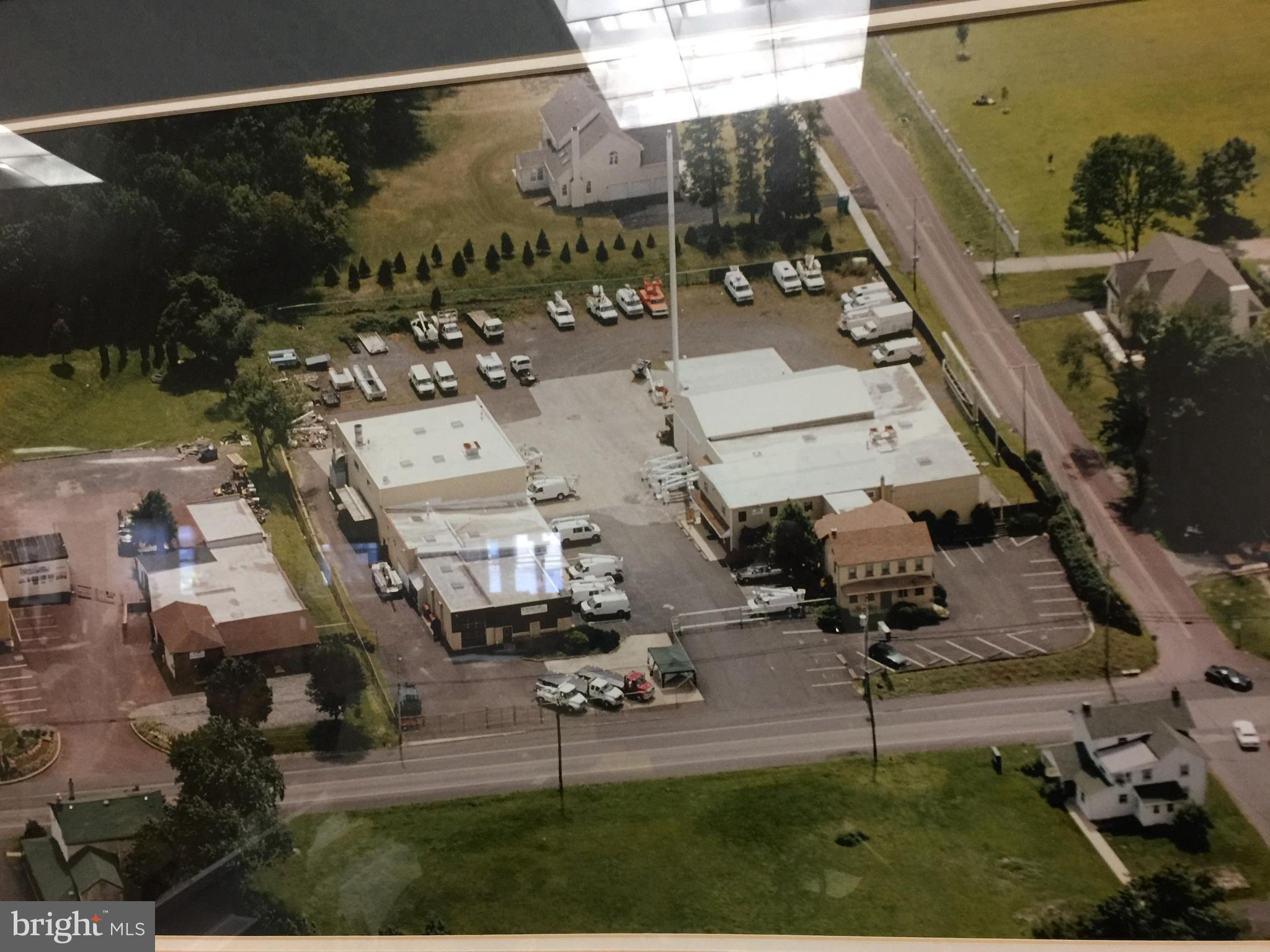 Special 21,340 SF commercial facility consisting of two buildings prominently sited on a 2.5 acre corner lot in growing Collegeville area near to #422 and #202. Prime investment property presently leased to long standing business or ideal business location. Featuring 5 high ceiling vehicular work bays, welding station, hydraulic bench station, machine shop, a down draft paint booth, truck wash bays, 3-phase power for welding, pneumatic power for tools, worker lounge and lunchroom, 2.5 bathrooms & showers. Additionally it has a warehouse with mezzanine storage and a retail customer showroom with office. The main office has two restrooms, computer room, conference room, washroom, second floor storage, and double stair tower. The original house offers an employee kitchen, a set of private offices, and a second floor apartment. The corner property with vehicular access from both frontages is mainly fenced with 3 gates and mostly paved with unpaved areas in rear. Sale subject to leases in effect with on-going business and mobile cell tower.