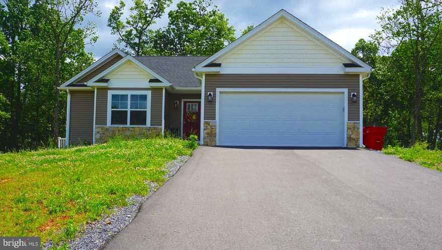 Beautiful almost new 3 bedroom and 2 full bath craftsmen rancher with a real stone water table on front and vinyl shake accents in front gables. Homes sites on a 1.5 acre wooded lot with peaceful mountain views-  SHOWSTOPPING EXPANSIVE CUSTOM KITCHEN!  stainless steel appliances- including microwave drawer , stainless chimney hood & dual oven propane range!, upgraded Blanco farm sink,  goose neck faucet, 9' by 4' level 4 Quartz kitchen island, glazed antique white cabinetry with many bells and whistles- glass, trash pull outs, rolling trays, spice pill outs, floating shelves!  Great room with Cathedral ceilings-Screened in porch off the kitchen with views of  lovely wooded area with mature trees.  .   Luxury vinyl hard wood throughout the main living  area and bedroom 3 . Main level laundry. Large master boosts a tray ceilings and en-suite bathroom with  enlarged 3 by 6 shower with a bench and alcove. Lovely foyer with chair molding and shadow boxes and 2 piece crown molding details- Attached garage with door opener and walk in access to foyer. Full unfinished basement that comes with a 3 piece rough in pluming single area way. In a beautiful private community with only 29 homes-paved road- 20 minutes to 81 nestled in the Jones Springs area of Berkeley County