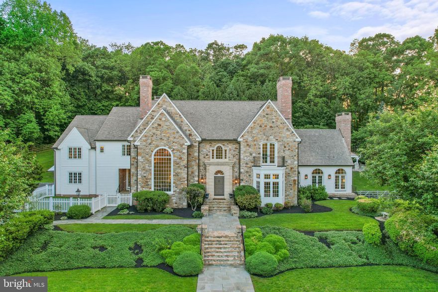 Welcome to your own slice of English charm nestled on 10.7 acres of picturesque
Chester Springs countryside (under Act 319 tax relief)! Step into luxury with this stunning 9,000 square foot English Manor designed by Peter Batchelor, where timeless elegance meets modern comfort.  Immerse yourself in the grandeur of this meticulously crafted estate boasting exquisite architectural details at every turn. From the eight fireplaces to the mahogany hardwood floors throughout to the intricate custom millwork and imported kitchen cabinetry, every corner exudes sophistication and grace. Surrounded by lush
greenery, manicured lawns and small pond with stream, this estate offers unparalleled
privacy and tranquility. Enjoy leisurely strolls through your expansive and tree lined
grounds or dive into luxury living with your own private oversized pool and pavilion with
grill, perfect for entertaining guests or simply unwinding after a long day. Whether you’re
hosting a lavish soirée or enjoying a quiet evening under the stars, this outdoor oasis
with stone patios is sure to impress. Retreat to your spacious master suite, complete
with a luxurious ensuite bath and sweeping balcony views of the estate. With ample
room for family and guests, including additional bedrooms, in-law suite, living areas and
library, there is no shortage of space to relax and recharge. Entertain in style in the
gourmet Clive Christian imported kitchen, equipped with top-of-the-line appliances,
custom cabinetry, French limestone flooring and soapstone countertops. Whether
you're preparing a casual meal for family or hosting a formal dinner party, this culinary
haven is sure to inspire your inner chef. Afterwards, move the party downstairs to the
English Pub alongside a Williamsburg Bar with stone hearth fireplace/billiards/theater
room. Finishing the lower level is a full bath with outdoor access, office, workshop,
laundry room and home gym.  Dreaming of your own event space, collector car storage,
or creative studio? Look no further than the 2,800 square foot timber frame barn
designed by King Construction and ready to be completed by the new homeowner! This
to-be completed timber-frame barn would offer heated and cooled entertaining space or
indoor parking for 10 or more cars, including two workshops. Need additional space for
entertaining guests or setting up a separate home office? The second- story mezzanine
would offer endless possibilities. The project is fully permitted and currently has a
completed foundation, septic system, grading, rainwater run-off basin and water hook-
up. New and recent upgrades include full exterior renovation (lasting ten months) with
Everlast composite siding and replacement of all windows with over 60 custom Marvin
Ultimate window units, refinished hardwood flooring throughout, brick accented
chimneys and exterior brick trim, new exterior doors, custom CHI garage doors, pool
renovation (including resurfacing, salt chlorination conversion, upgraded equipment and
cover) and outdoor pavilion with grill, outdoor playhouse, dual Generac 22kw generators
with separate 1,000-gallon propane tank for generators only, Thermador oven and
dishwasher, four high-end energy efficient HVAC systems, two water heaters, well
pump, water treatment system and washer/dryer. Don't miss this rare opportunity to
own a piece of private English countryside paradise. Schedule your private tour today
and experience the epitome of luxury living!! Parcel ID 25-10-0003-0400 is attached to
this beautiful estate