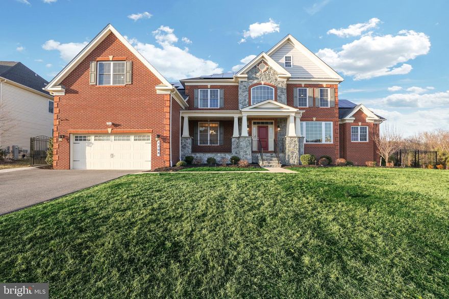 Step into the world of unparalleled luxury within the esteemed Arundel Forest enclave in Severn, MD, where sophistication meets grandeur in this magnificent mansion situated on a premium lot. Every inch of this residence exudes opulence, promising an exquisite living experience tailored for both indulgence and entertainment. 

This extraordinary estate boasts a plethora of lavish upgrades, featuring seven bedrooms, including three luxurious primary suites outfitted with top-tier amenities such as prewiring for 7.1 surround sound. Enjoy the added benefit of paid-off solar panels, ensuring sustainable living without compromising on luxury. Step outside onto the expansive patio, adorned with stunning granite city pavers, leading to a captivating stone-seated fire pit, all within a meticulously crafted wrought-iron fence and surrounded by lush privacy trees.

No detail is overlooked in this home, with three gas fireplaces, 400 AMP circuit breakers, and multiple 75-gallon water heaters enhancing the experience of extraordinary living. Embrace the convenience of Ethernet ports in nearly every room, seamlessly integrating modern technology into the fabric of luxury living.

Upon arrival, be greeted by the majestic stone waterbed and brick stone front facade, complemented by an inviting spacious porch, offering a glimpse of the splendor within. Enter through the  entryway, where a grand dual cased stairway, adorned with espresso stained white oak stairs and wrought iron spindles, welcomes you into a soaring two-story foyer adorned with elegant design elements. Gleaming staggered hardwood planks, embellished with chair rail, shadow box, crown molding, and tray ceilings, create a timeless ambiance, setting the stage for refined living.

Traverse the enchanting staircases to discover the expansive family room, boasting coffered ceilings and a captivating stone hearth embracing a gas fireplace. A sunlit conservatory awaits, perfect for gatherings or as a serene office space. Find solace in the main-level primary suite, featuring cathedral ceilings, dual walk-in closets, and a palatial ensuite bathroom adorned with exquisite marble-like tiles and double vanities, complete with custom cabinetry and an ultra-luxurious water room for added privacy.

Designed for entertaining, the main level unfolds seamlessly, revealing formal dining and living spaces exuding sophistication. The gourmet kitchen, the heart of the home, features a heavy-duty cooktop, stainless steel draft hood, two spacious pantries, and sprawling luxurious countertops. Transition seamlessly to the sunroom with cathedral ceilings and private outdoor access, leading to the beautiful paver patio and stone-seated fireplace amidst lush landscaping and wrought-iron fencing. The main level also includes a mud area, half bath, laundry area, and entry to the expansive 2-car garage equipped with 2 Tesla chargers.

Ascend to the upper level to find a primary suite fit for royalty, complete with tray ceilings, a gas-powered fireplace, 3 walk-in closets, and a spa-like ensuite bathroom. Four additional spacious suites, each with ensuite bathrooms and walk-in closets, ensure unparalleled comfort for residents and guests alike.

The lower level offers yet another primary suite, a sprawling recreational room, a brand-new home theater, and a utility room equipped with top-of-the-line amenities. With seven bedrooms, seven bathrooms, and one half bath, this estate stands as the epitome of refined living in Toll Brother’s Arundel Forest Community. Experience luxury living at its finest, surrounded by exceptional amenities and a convenient location near Fort Meade, Northrop Grumman, and major transportation routes. PAID OFF SOLAR PANELS.