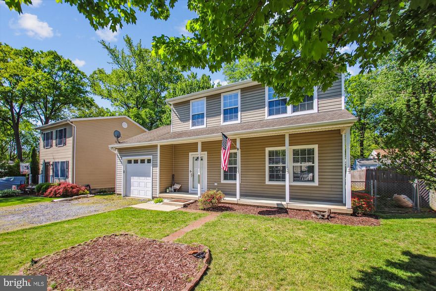 Charming Colonial with a full front porch and garage, located in a water-privileged community offering five beaches, piers, boat slips, playgrounds and everything that defines Chesapeake Bay living. Step inside to gleaming floors and an open-concept layout centered around a cozy gas fireplace with a stunning stone tile surround.  The spacious kitchen flows into a casual dining area featuring a built-in window seat—perfect for morning coffee or evening meals.  Just off the kitchen, a maintenance-free deck (installed in 2020) invites you to grill, entertain, or simply relax. The fully fenced backyard includes a shed and ample space to create the flower or vegetable garden you’ve always wanted.  Upstairs, you’ll find two generously sized bedrooms and a spacious owner's suite—ideal for rest and retreat.  This is a wonderful home in a vibrant neighborhood with local shops and restaurants just around the corner. Enjoy easy access to Baltimore, Washington, D.C., and the Eastern Shore.  Be sure to view the property website with floor plans!