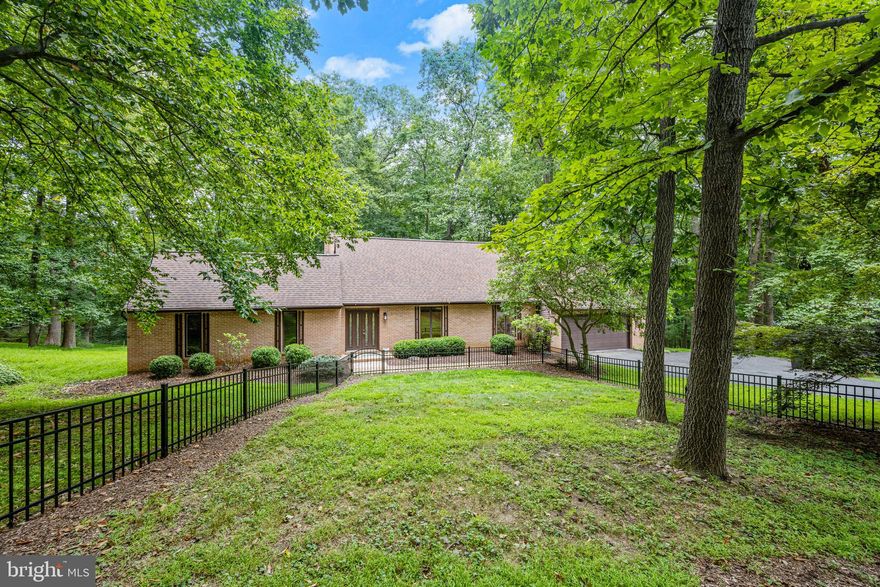 Immediately upon pulling into the driveway of this well-maintained, contemporary-style home on a parklike 1.21-acre lot situated on a quiet cul-de-sac, you will realize that you have reached the pinnacle of your home search! The main level owners’ suite, two-story living area, recent roof, gourmet kitchen, and luxury baths set this home apart from the rest. Its open and inviting layout was very well thought out. Entering from the brick pathway through the stained-glass French doors, you’ll be greeted by a large open foyer and a two-story living room and dining room with a wood-beamed cathedral ceiling and wide-plank dark wood floors. The updated black-and-white balustrades lead you up from here to the second-level overlook, where you’ll find two more well-appointed bedrooms, a full bath, and storage. Adjacent to the living room, to the left of the entry foyer is the main level owners’ suite with sitting area and two walk-in closets. Its ensuite luxury bath features honed travertine tile warmed by an in-wall electric heater. A free-standing air-jetted tub sits under a window across from the separate frameless glass shower accented by a dark floating vanity with porcelain white top and dual vessel sinks. Enjoy inverter-provided, individually zoned heat and A/C in your owners’ oasis! Back into the foyer and past the elegantly decorated half bath, you’ll find a cozy family room with two-piece crown molding, propane fueled fireplace, and sliding glass doors leading to the screened in porch. All open to the breakfast area and gourmet kitchen, laundry room, and garage access. The stone counters and backsplash enhance the white kitchen cabinetry. The deep, white porcelain sink is situated perfectly to gaze out the window into the woods. Stainless steel appliances include a bottom-freezer refrigerator with water and ice on the door, double-wall oven/microwave combination, and dishwasher. Don’t miss the cabinet-front, hooded exterior exhaust over the glass cooktop! Completing this level of living and moving outdoors is a large, screened porch with ceiling fan, ceramic tile flooring, and additional open decking for grilling or relaxing in the sun. Step down from here into the private backyard, which backs to woods that lead all the way down to Loch Raven Dam. A concrete patio under the screened porch serves as additional entertainment space and is also accessible from the fully finished basement with a second half bath and loads of storage space. Bonus features include a 12 BTU Kohler propane powered generator(2018) Nutone central vacuum system, second fridge and built-in cabinetry, professional epoxy flooring, shelving, and slat wall systems in the two-car oversized front-entry garage. The extra area in the rear of this garage is built out and workshop worthy. Loch Raven Reservoir is a park and fishing center known to have great trails for hiking, trail running, or mountain biking. Join the kayak rental club, bring your canoe, or rent an electric motorboat or rowboat and fish or just relax all day! Central air is supplied throughout via electric heat pump. The previous owner had installed removable supplemental window units in the upstairs bedrooms and the current owner wanted separate zoning in her main level primary adding a mini split inverter there just a few years ago.