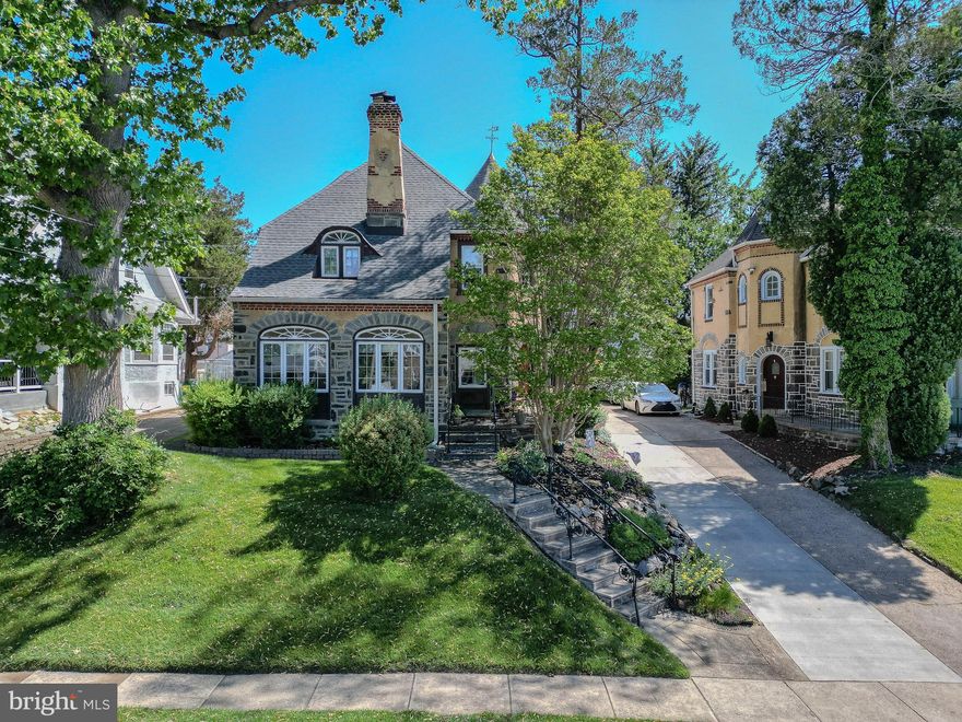 You'll never want for any of life's little pleasures if you are the new proud owner of this amazing, architecturally pleasing 5 BR, 2 1/2 bath home in the Beverly Hills section of Upper Darby! What curb appeal! A real stunner! Ageless beauty, for sure! This home is your suburban oasis! There are only a few homes like this in the area, and they don't come up very often! Not only will you be blown away by the 1920's features, like arched windows, turned staircases, turret vestibule entry via the original  wooden arched front door, alcoves, sunburst enhancements on many of the windows & textured plaster walls...but you will feel the vibe pouring out of every room as you roam through all 3 stories. It all comes from the owners, who have raised  their family here over the last 45 years w/much love & devotion, & who have treated this place with the same love, taking care of every nook & cranny. The way #7205 sits up a bit high up on the street just adds to its elegance. The quality of workmanship is quite evident - the original stucco exterior decorated w/stone & brick accents, even on the stunning, capped chimney, the patios decorated w/floral touches that enhance the entry area, & the stately, front, cascading steps trimmed w/wrought iron railings   just lovely! Some terms of endearment: include beautiful hardwood floors, the quaint telephone inset in the front hall, lots of CF's & 7 window ac's, all banisters have been replaced & painted, many casement windows, dimensional shingled roof, stone-trimmed window wells & wood wainscoting. More perks- include a spacious LR w/a gas, stone FP (just inspected recently), a bright & cheery enclosed sunroom  w/11 windows that makes you feel like you are sitting  in a garden, a formal DR w/plenty of room for your family & friends, a bonus room ( now used as a music room, but could certainly be a den, an office or a playroom), a laundry room w/cabinets, shelving, a laundry sink & a  counter for folding located  just off the remodeled eat-in  kitchen w/space for any size table, a double stainless steel sink, tile & glass backsplash, medium cherry cabinets,  and white appliances (including  side-by-side fridge with ice maker, DW and  gas stove). The back door leads out to even more surprises! A partially fenced, lush yard that comes complete w/a large, attached storage house w/shelving & a loft, a basketball stand & hoop, as well as a 24 ft diameter/4' high , well maintained above ground pool w/an inset for pool furniture. The entire pool deck is fenced, it's landscaped all around the base, & there is exterior lighting which makes for a  peasant night time swim. The exterior of the house  boasts accent lighting as well. Note the period-style windows at the turned staircase to the 2nd  & 3rd floors. The staircases show off  runners held by brass rods to match the throw rugs. Here on the 2nd floor you'll find the primary BR suite w/attached dressing room & a  walk-in cedar closet, plus 3 other good-sized bedrooms. All the BR's boast walk-in closets, actually. The elegant, black & white tiled  4-piece hall bath shows off a deep tub, stall shower, vanity sink w/granite top & 2 period-style windows - very special! Take one more flight up  on the extra wide steps to the spacious & gracious 3rd floor, complete w/the 5th BR showing off three half moon crescent windows & a large cream & rust open bonus room. The 3rd floor bath is adorable! It features a bowl sink & clawfoot tub, deep closet and wainscoting. This top floor space would make a perfect suite for your teens or visiting guests. The lower level has a  paneled finished section w/painted floors as well as storage rooms galore for all your extra items & holiday decorations. The powder room comes w/a vanity sink. In the utility room, check out the 200 amp electric service, Weil McLain gas, hot water heater &  Bradford White Defender 40 gal. hot water heater & workbench. The long, shared driveway can fit 3+cars! FREE  HOME WARRANTY!  Spoil yourself!