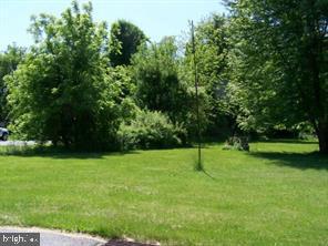 Commercial Zoning Vacant open level lot, with a small stream running through back corner of property. Public sewer is available. Quiet and secluded area with mature landscaping, perfect for your next build.