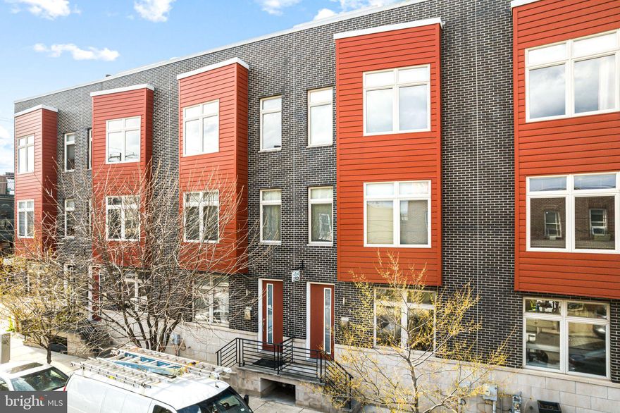 Nestled on a serene, tree-lined street in the coveted Fishtown neighborhood, this meticulously designed home offers over 2,500 square feet of luxurious living space—an ideal blend of sophistication, comfort, and everyday ease. Just moments from the area’s vibrant dining and cafe scene, the location delivers true urban convenience while still feeling like a peaceful retreat.
Step inside to an expansive first floor designed for modern living and effortless entertaining. The open-concept layout is bright and inviting, highlighted by soaring ceilings, extra-wide windows, and a stunning open staircase that creates a striking architectural focal point. Natural light fills the space throughout the day, enhancing the home’s clean lines and refined finishes while maintaining a warm, welcoming feel.
The second floor offers two generously sized bedrooms and a chic, modern hall bath thoughtfully designed with a double vanity and a private area for the tub and toilet—providing both style and added privacy. An upper-level laundry room is conveniently located nearby, adding a practical touch that makes daily life feel seamless.
On the third floor, the primary suite is a true retreat. Spacious and serene, it features a large walk-in closet and a spa-inspired en-suite bath complete with a stand-alone shower, a separate soaking tub, a double vanity, and a large linen closet—perfect for relaxing and recharging in comfort.
The lower level expands the home’s flexibility even further, featuring a fourth bedroom, a third full bathroom, and a versatile flex space that can be tailored to your needs—whether you envision a home office, gym, media room, or play space.
Outdoor living is equally impressive. Head up to the expansive rooftop deck and enjoy panoramic views in multiple directions—an incredible setting for entertaining, dining al fresco, or unwinding at the end of the day. The private, fenced backyard includes a paved patio, offering another quiet space to gather with friends or enjoy a tranquil moment outdoors.
Equipped with a dual-zone HVAC system for comfort and efficiency, this home is designed to embrace light, space, and effortless living at every turn. Experience elevated city living in one of Philadelphia’s most sought-after neighborhoods—where luxury, flexibility, and location come together beautifully.