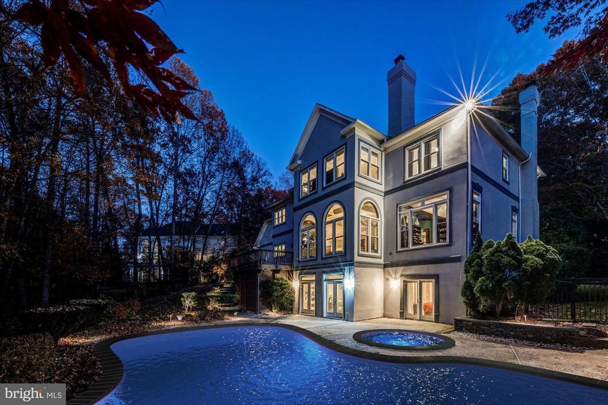 Set on nearly an acre, this grand Colonial offers timeless elegance, exceptional craftsmanship, and resort-style living - convenient to downtown Vienna, Tysons, and Fairfax.

A dramatic two-story marble foyer with a sweeping curved staircase opens to the formal living room with a wood-burning fireplace and gleaming hardwood floors. The spacious dining room features tall Palladian windows and connects to a butler’s pantry with glass-front cabinetry and granite counters - a perfect aid for entertaining.

The gourmet kitchen impresses with rich cherry cabinetry, a large center island with bar seating and a five-burner cooktop, and top-tier stainless and cabinet-front appliances. Just beyond, the step-down family room showcases soaring Palladian windows, coffered ceilings, built-ins, and a stunning floor-to-ceiling stone fireplace. The large deck overlooking the pool and serene backyard is conveniently accessed from the kitchen / family room area. A handsome main-level library with custom cherry built-ins provides an ideal work-from-home retreat.

Upstairs, the luxurious primary suite offers cathedral ceilings, a sitting room, and a spa-like bath with frameless glass shower and whirlpool tub, plus three walk-in closets. Each of the three secondary bedrooms offers its own distinctive charm and generous space.

The walk-out lower level is designed for fun and relaxation, featuring a large recreation area with a full bar, a fifth bedroom, and a fourth full bath. French doors open to the backyard oasis - complete with a heated in-ground pool, hot tub, and expansive patio - perfect for summer get togethers. In front of the home, the 100+ ft set back and level yard provide an excellent place for sports an play. The generous driveway and oversized three-car garage allows for space for cars and a place for all the extra gear (bikes, strollers, sports equipment, etc).

This exceptional home blends classic luxury with modern amenities in one of the area’s most sought-after communities.