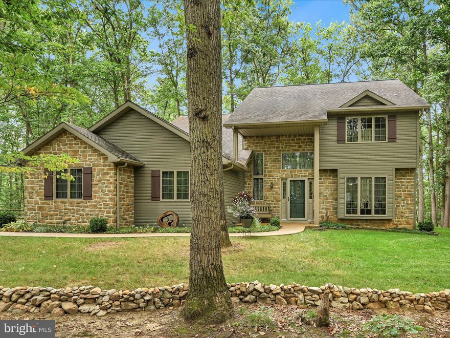 Your own slice of Paradise that includes 2 detached garages, large enough for RV parking.  This move in ready Custom Built Home is situated on  wooded 2.36 acres.  Ideal for the car, truck, motorcyclist enthusiast with 6+covered garage spaces.  Are you looking for a workshop?  Use one of the RV garages for a workshop with storage above.  One owner home that has been continually updated throughout the years.  Enjoy the wildlife from the Gazebo and the Fire Pit.  There is even a hot tub overlooking the woods in the screened in porch.  Hardwood floors throughout, remodeled kitchen which includes a large Island with storage, stainless steel appliances.  Too many features to list.  Schedule your showing today before this one of a kind property is gone!