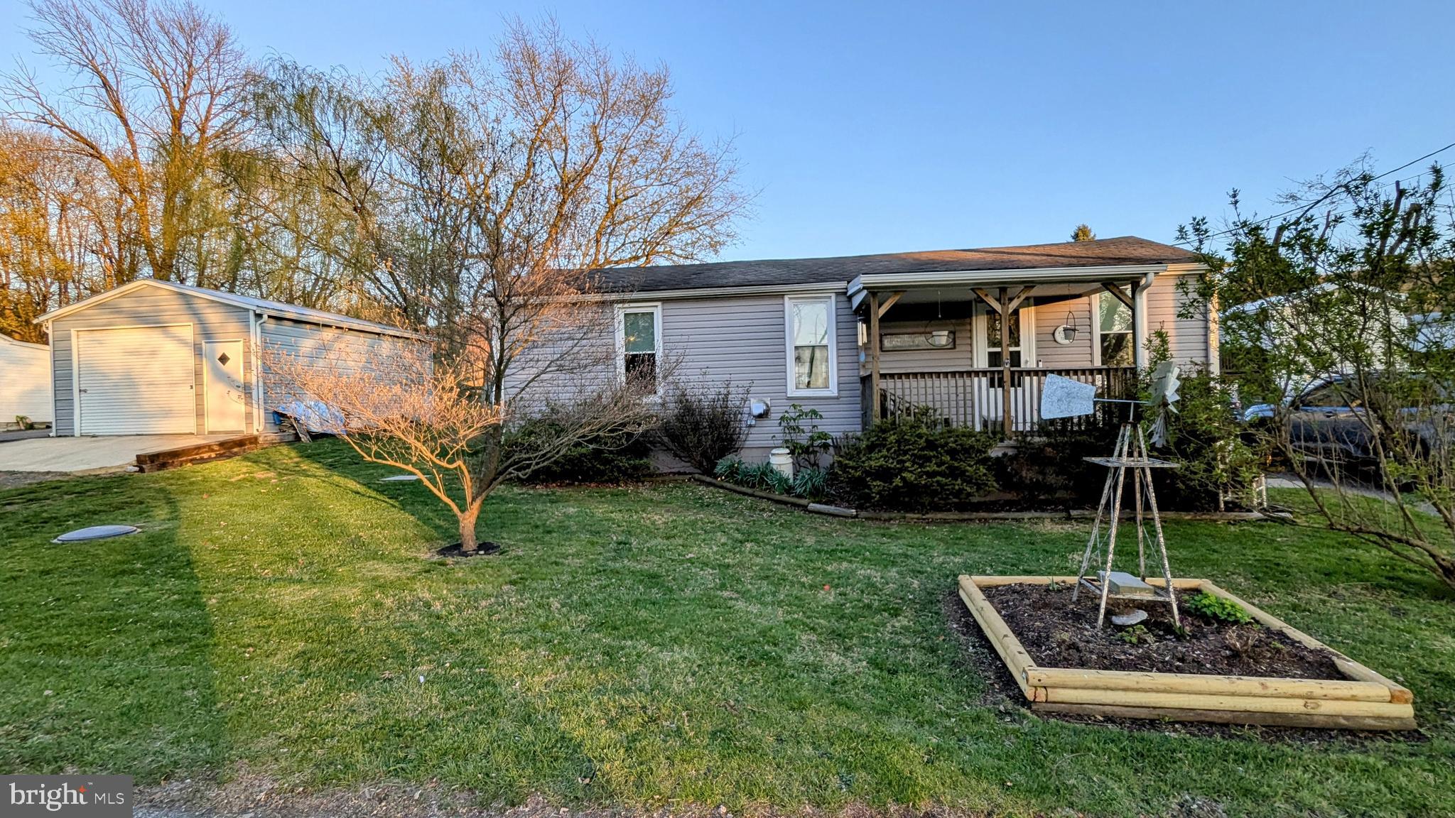 OPEN HOUSE this Sat. April 19 ** 1-3 PM ** Welcome Home ** This immaculate and fully updated rancher offers convenient first-floor living with 3 spacious bedrooms, 1 full bathroom, an office/den, and a cozy sitting room, all in excellent condition. The chef’s kitchen boasts hickory solid wood cabinets, quartz countertops, a sleek black and white backsplash, stainless steel appliances, a gas stove with hood range (propane), and plenty of prep and storage space. Additional interior features include luxury vinyl flooring, new carpet, fresh paint, a pellet stove, propane heat, a high-efficiency air filter, new washer and dryer, and new laundry cabinets for extra storage. The home is well-maintained with a roof from 2011, newer siding and gutters (2020), and newer windows. French doors bring in natural light and lead to a large, fully fenced backyard with mature landscaping—perfect for entertaining—featuring a firepit, large shed, Rubbermaid shed, and an oversized detached pole building with a wood stove, ideal for a workshop or hobby space. There's parking for up to 5 vehicles, a welcoming front porch, and a backyard entertainment area. Conveniently located near Ft. Ritchie Center and the lake, this home also offers public water and sewer, making it a truly move-in-ready gem.