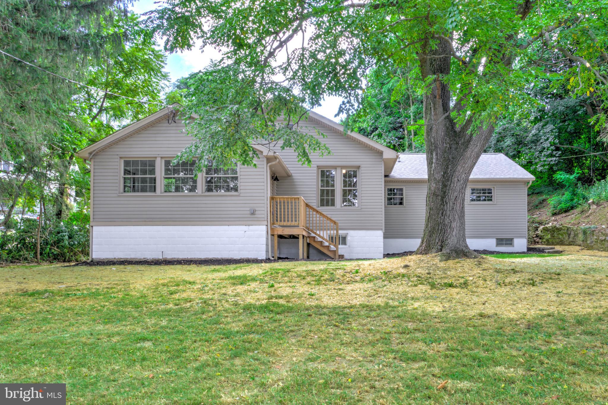 Discover the charm of country living at 2560 Iron Springs Rd, a beautifully renovated 3-bedroom, 2-bathroom raised ranch tucked away in a peaceful rural setting just outside Waynesboro! Step inside to a bright, open floorplan with a welcoming nook filled with natural light. The main living, dining, and kitchen areas flow seamlessly together, featuring brand new luxury vinyl plank flooring throughout. The stunning new kitchen showcases crisp white cabinetry, quartz countertops, a stylish tile backsplash, stainless steel appliances, and a peninsula that offers both abundant counterspace and eat-in dining options. A separate mudroom with laundry adds convenience to the main floor. Three cozy bedrooms offer plenty of space, including a spacious primary suite with a private ensuite bath featuring a double vanity and a beautifully tiled walk-in shower. An additional full bathroom with a tub/shower combination serves the remaining bedrooms. Practical spaces include a clean basement and attic, providing ample storage. Outside, enjoy a large detached two-car garage (perfect for hobbies!) and a brand new septic system that ensures peace of mind for years to come. A brand new, efficient HVAC system will keep you cozy this fall and winter. With its fresh renovation, functional layout, and quiet location, this move-in ready home is the perfect balance of comfort and countryside living; come check it out!