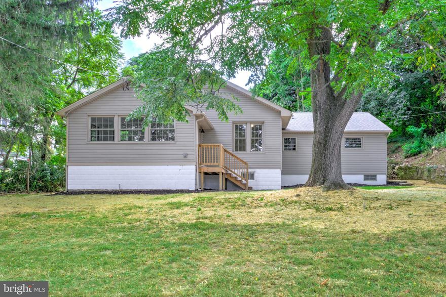 Discover the charm of country living at 2560 Iron Springs Rd, a beautifully renovated 3-bedroom, 2-bathroom raised ranch tucked away in a peaceful rural setting just outside Waynesboro! Step inside to a bright, open floorplan with a welcoming nook filled with natural light. The main living, dining, and kitchen areas flow seamlessly together, featuring brand new luxury vinyl plank flooring throughout. The stunning new kitchen showcases crisp white cabinetry, quartz countertops, a stylish tile backsplash, stainless steel appliances, and a peninsula that offers both abundant counterspace and eat-in dining options. A separate mudroom with laundry adds convenience to the main floor. Three cozy bedrooms offer plenty of space, including a spacious primary suite with a private ensuite bath featuring a double vanity and a beautifully tiled walk-in shower. An additional full bathroom with a tub/shower combination serves the remaining bedrooms. Practical spaces include a clean basement and attic, providing ample storage. Outside, enjoy a large detached two-car garage (perfect for hobbies!) and a brand new septic system that ensures peace of mind for years to come. A brand new, efficient HVAC system will keep you cozy this fall and winter. With its fresh renovation, functional layout, and quiet location, this move-in ready home is the perfect balance of comfort and countryside living; come check it out!