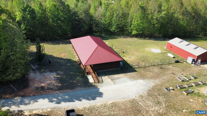 Welcome to your serene retreat at 469 Jenkins Church Rd, where tranquility meets modern comfort on 23.70 private acres. This charming cedar log cabin features a wrap-around porch perfect for relaxing and enjoying peaceful views, all while staying conveniently close to Powhatan, Richmond, Farmville, and Charlottesville. Inside, soaring cathedral ceilings highlight the spacious living room, creating a warm, open feel. The kitchen offers ample cabinetry and a generous eat-in area, making it ideal for gatherings and everyday living. The primary suite provides a private escape with cathedral ceilings, a ceiling fan, plush carpeting, and a walk-in closet. The en-suite bath includes a stand-up shower for added comfort. Two additional bedrooms offer cozy spaces for family or guests. A separate laundry room adds convenience, while the impressive 30x50 garage can accommodate up to four vehicles, a workshop, or storage for hobbies. The property also includes a chicken coop and plenty of space for outdoor living or animals. A propane Generac whole-house generator ensures peace of mind year-round.  Enjoy the best of country living with easy access to nearby towns. Schedule your private showing today and make this exceptional property your own.
