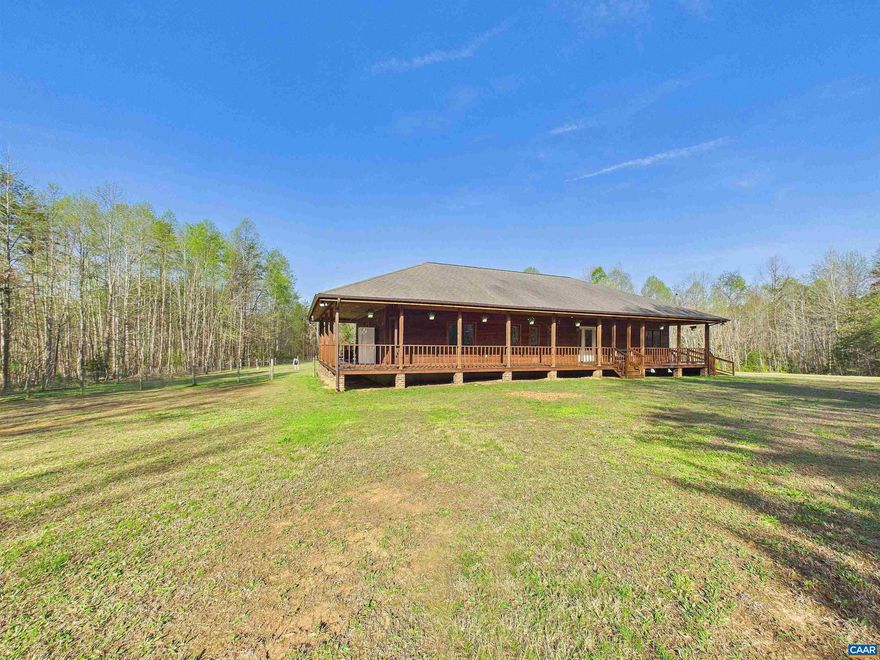 Welcome to your serene retreat at 469 Jenkins Church Rd, where tranquility meets modern comfort on 24.59 private acres. This charming cedar log cabin features a wrap-around porch perfect for relaxing and enjoying peaceful views, all while staying conveniently close to Powhatan, Richmond, Farmville, and Charlottesville. Inside, soaring cathedral ceilings highlight the spacious living room, creating a warm, open feel. The kitchen offers ample cabinetry and a generous eat-in area, making it ideal for gatherings and everyday living. The primary suite provides a private escape with cathedral ceilings, a ceiling fan, plush carpeting, and a walk-in closet. The en-suite bath includes a stand-up shower for added comfort. Two additional bedrooms offer cozy spaces for family or guests. A separate laundry room adds convenience, while the impressive 30x50 garage can accommodate up to four vehicles, a workshop, or storage for hobbies. The property also includes a chicken coop and plenty of space for outdoor living or animals. A propane Generac whole-house generator ensures peace of mind year-round.  Enjoy the best of country living with easy access to nearby towns. Schedule your private showing today and make this exceptional property your own.