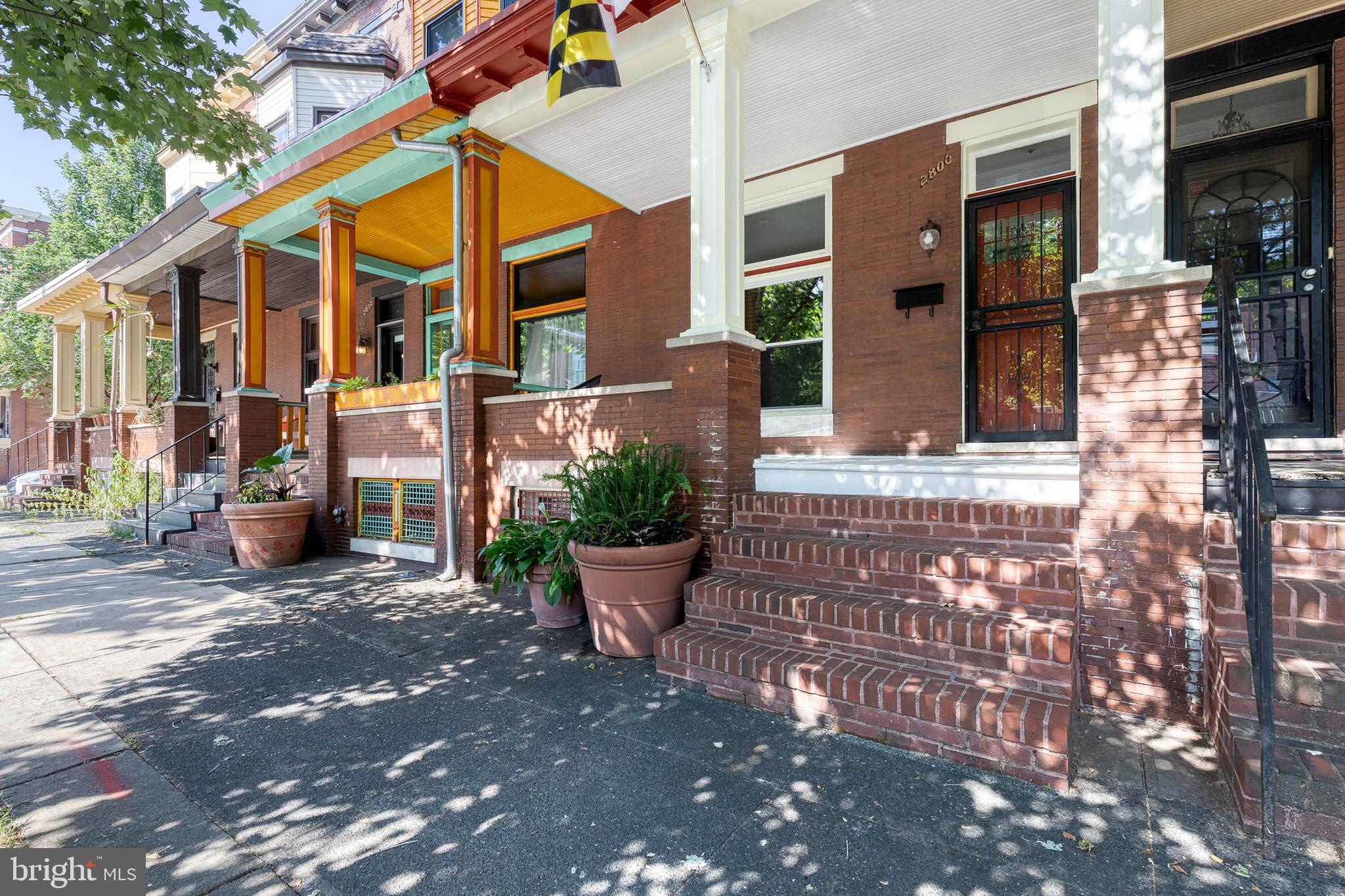 Charming Charles Village townhome blending classic character with modern updates. Step onto the welcoming front porch and into a bright, open layout with hardwood floors and high ceilings throughout. The dining room features exposed brick and leads into a spacious kitchen with stainless steel appliances. From there, enjoy a cozy screened-in porch and a generously sized backyard with a parking pad for added convenience. Upstairs offers three comfortable bedrooms, a full bath, and the convenience of second-floor laundry, sun drenched by skylight windows. The large lower level (accessible from outside) offers excellent storage or potential to finish with existing heating/cooling and water lines. Updates include windows and appliances (approx. 10 years) and HVAC (2014). Highly sought after location near R House, Johns Hopkins University, the BMA, Wyman Park and more.
