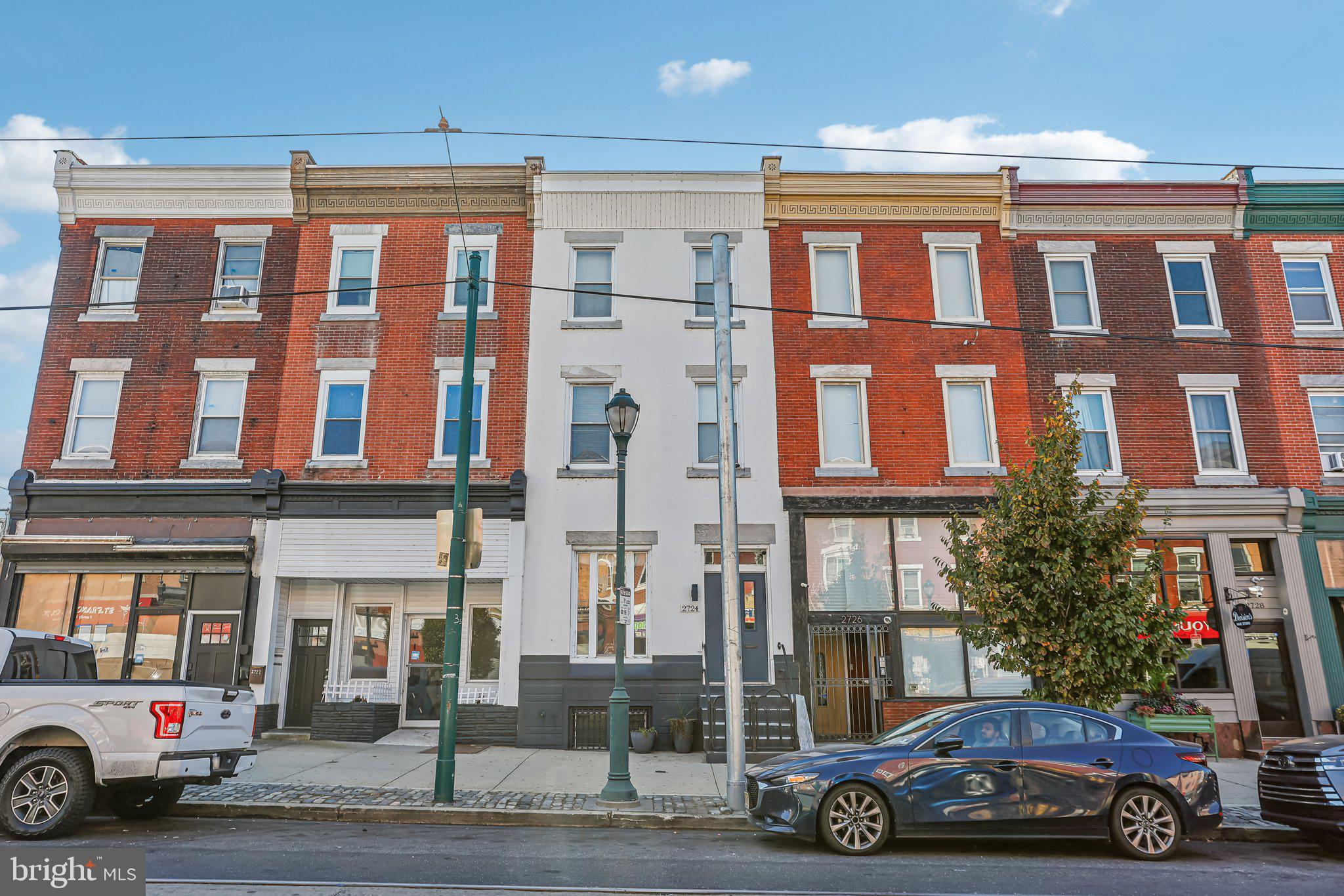 Welcome to 2724 W Girard Ave, an extraordinary 5-bedroom, 2-bathroom property with highly coveted CMX-2.5 zoning, offering unparalleled versatility in the heart of Philadelphia. Situated on bustling Girard Avenue, this property is perfectly positioned between the vibrant neighborhoods of Fairmount and Brewerytown, surrounded by thriving businesses, cultural attractions, and residential charm.
The striking curb appeal includes elegant marble steps and custom wrought-iron railings, hinting at the timeless craftsmanship within. Inside, an expansive open-concept living and dining area greets you, framed by stately columns, soaring ceilings, and recessed lighting that amplifies the natural light. The flow leads to a chef-inspired galley kitchen featuring stainless steel cabinetry, sleek quartz countertops, and a bold glass tile backsplash. Beyond the kitchen, the enclosed rear yard offers endless possibilities for outdoor seating, dining, or entertainment.
The second floor boasts two generously sized bedrooms—one at the front and one at the rear—alongside a versatile middle room that could serve as an office, den, or additional bedroom. A fully updated bathroom on this level features a chic glass-enclosed shower, contemporary tiling, and a stacked laundry area for convenience.
On the third floor, discover even more potential with two additional bedrooms, including a spacious double room perfect for a home office, studio, or creative retreat. A second full bathroom completes this level.
A full basement provides abundant storage or room for future customization as a workspace, fitness area, or more. Throughout the home, a sophisticated blend of vintage and modern flooring enhances its unique character.
The CMX-2.5 zoning offers incredible opportunities for mixed-use, including retail, office, or live-work possibilities, making this property a rare gem for entrepreneurs, investors, or those seeking a unique residence.
With easy access to major highways, public transportation, Fairmount Park, museums, Boathouse Row, and a wealth of local amenities, this property is positioned for success—whether as a private home, business, or both. Don’t miss the chance to explore the potential of this exceptional property.
