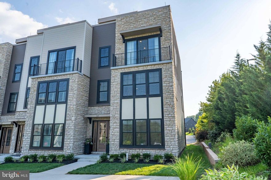 Welcome to this warm yet sophisticated end unit in the highly desirable community of Newtown Walk at Ellis Preserve. This beautiful 4-story end unit home offers 3 spacious bedrooms, 3.1 bathrooms, and is loaded with upgrades. Perfectly tucked away in one of the quietest and most sought-after locations in the neighborhood, this home offers the best of both worlds—serenity at home and unmatched walkability to newly opened shops, restaurants, and amenities.
This stunning townhome features a private 4-stop elevator with upgraded auto-close gate, designer finishes, and sophisticated upgrades throughout. Designed with technology in mind, the house also boasts ethernet connections on all floors including the rooftop and an advanced security/environment control system.  The entry level welcomes you with a stylish foyer and a versatile first-floor bedroom or office with a full bath featuring upgraded shower tile. From here, you’ll also find access to the elevator and a painted 2-car garage.
Upstairs, the second-floor loft-style open-concept living area boasts soaring 10’ ceilings, custom automated blinds, engineered hardwood floors throughout, recessed lighting, and large windows that fill the home with natural light. The family room features a gas fireplace with  one of a kind tile surround, flanked by built-in bookcases, and expansive windows that bring in views of lush trees and greenery—one of the many benefits of being an end unit. The chef’s kitchen is a showstopper with quartz countertops, upgraded KitchenAid appliances including a professional 6-burner cooktop, double wall oven, and microwave, french-door refrigerator, plus an oversized island with storage. The dining room, surrounded by windows, offers beautiful treetop views along with upgraded built-in cabinetry that provides extra storage and a coffee bar—perfect for hosting family and friends or serving buffet-style meals when entertaining.
On the third floor, the primary suite showcases custom millwork, a spa-like bathroom with an oversized shower, smart toilet, and a walk-in closet. The laundry room is thoughtfully designed with an Electrolux steam washer/dryer, cabinetry, and a quartz countertop. A bright third bedroom offers a Juliet balcony, upgraded and luxurious tiled shower, and a large walk-in closet. 
Head to the top floor—via stairs or elevator—to your private rooftop retreat, the ideal space to unwind and take in stunning sunset views and surrounding greenery. This outdoor oasis is equipped with natural gas hookups, making grilling and outdoor entertaining a breeze.
With easy access to Routes 3, 252, 476, and Philadelphia International Airport, this home combines upscale convenience with a walkable lifestyle. This is a rare opportunity to own an end unit perfectly positioned in one of the most private locations in the neighborhood.