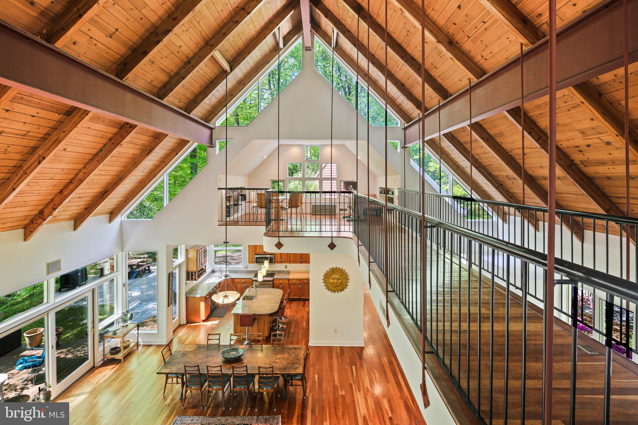 Stunning custom home on nearly 4 acres in Chapel Woods! This open-concept beauty offers one-level living with soaring ceilings, a spacious living/dining/kitchen area, and a serene primary suite with two private offices—each opening to a full-length rear deck. The opposite wing includes a powder room, patio access, drop zone, oversized two-car garage, and enclosed workshop. Upstairs features 3 bedrooms (one with a private deck) and a large loft. The walk-out lower level includes a family room, full bath, and tons of storage. Bright, spacious, and perfect for entertaining—this home is truly one-of-a-kind! HVAC & Hot Water Heater within past 10 years, Roof 2019