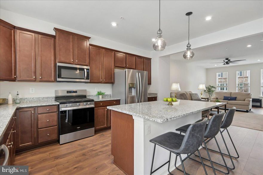 Welcome to this spacious, three-level townhome with a two-car garage, located in the popular community of The Ridges in Hanover. The entry level features a home office and garage access. The second level includes a Gourmet Kitchen with a large island, upgraded cabinets, granite countertops, and stainless steel appliances. The second-floor oversized deck provides a lovely outdoor space off the rear of the home. On the upper level you will find the large primary suite, which features a spacious walk-in closet and a spa-like bath with an oversized shower and dual vanities. Two additional bedrooms, a full bathroom and the full-size washer and dryer complete this level. Don't miss your chance to make this exceptional home yours!