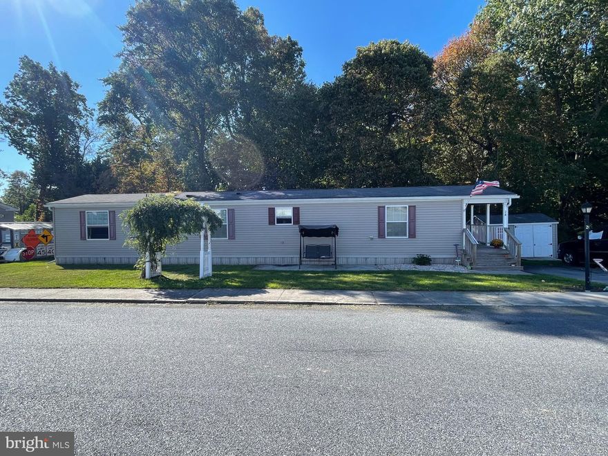 This is your opportunity to own a charming 2 bedroom home on the corner lot in Oak Ridge where the lot rent is $360 and includes water, sewer, trash and snow removal.    Backing up to woods, enjoy porch life at a slow pace in a rural setting.  The living room and kitchen are bright and open.  The hallway leads to two bedrooms, full bath and laundry.   Propane tank is owned.