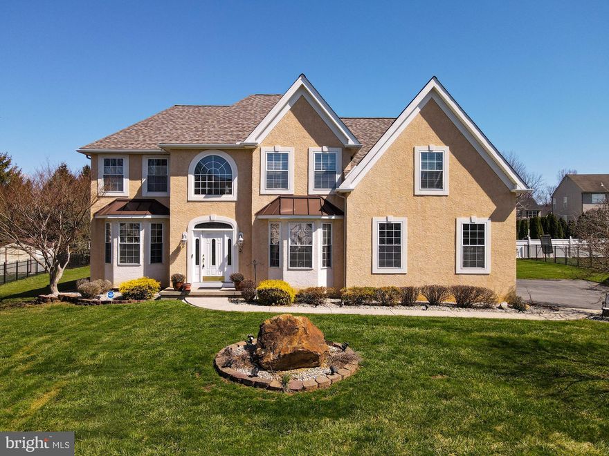 Welcome to this stunning 4-bedroom, 2.5-bath Colonial located in the highly sought-after Lafayette Meadows community, where timeless elegance meets modern comfort. *BRAND NEW ROOF IN 2025, NEWER AC, FURNACE AND WATER HEATER!* Hardwood floors flow throughout the main level, beginning in the impressive 2-story central hall foyer adorned with baseboard and crown molding, a Palladian window, and dual coat closets. The formal living and dining rooms both feature beautiful bump-out windows, with the dining room further enhanced by chair rail detailing, perfect for entertaining. The dramatic 2-story family room boasts a tiled gas fireplace with mantel and recessed lighting, creating a warm and inviting gathering space. The updated eat-in kitchen is a chef’s delight, offering granite countertops, 42-inch cabinets, a tiled backsplash, recessed lighting, a center island with breakfast seating and pendant lights, a pantry, and a bright eating area with sliding door access to the backyard. A single French door leads to a private den/study, complemented by an additional office with baseboard and crown molding. A powder room with pedestal sink and a convenient laundry room with utility sink complete the first floor. Upstairs, double doors open to the luxurious primary suite featuring a vaulted ceiling, ceiling fan, recessed lighting, chair rail accents, and custom-design his and hers walk-in closets. The en-suite bath offers tile flooring, dual vanities, a tiled corner soaking tub, tiled walk-in shower, and linen closet. Three additional generously sized bedrooms with ceiling fans and a full bath with tile floors, dual sinks, and a tiled tub/shower combination complete the second level. Step outside to a beautifully maintained level yard with a paver stone patio—ideal for outdoor relaxation and entertaining. A 2-car side-entry garage and paved driveway add to the home’s exceptional appeal. Conveniently located close to major highway US-22 for easy commute, Riverview Country Club, Forks Community Park, scenic Delaware River, Crayola Experience, shops, restaurants and so much more! This is a rare opportunity to own a truly refined home in one of the area’s most desirable neighborhoods!