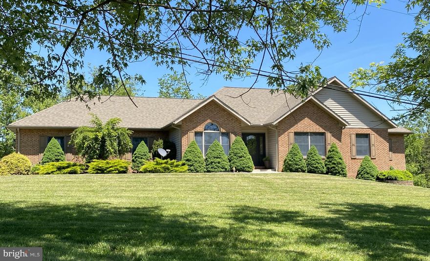 Discover your perfect sanctuary with this charming one-story brick-front home nestled on nearly 3 acres of thoughtfully wooded land.  The spacious open floor plan welcomes you with inviting living spaces, highlighted by a cozy gas fireplace.  Step outside to a large outdoor entertaining area, partially covered, ideal for gatherings and enjoying nature.  This home offers four generously sized bedrooms and two full bathrooms, with plumbing already in place for a third bathroom in the basement—perfect for future expansion. The primary suite provides private access to the outdoor deck, a large walk-in closet, and a luxurious ensuite featuring a double vanity and shower.  The finished basement boasts a sizable family room and abundant storage, providing comfort and practicality.  The paved driveway leads to a two-car garage, which conveniently opens into the first-floor laundry room.  Whether you're seeking tranquility, space for entertaining, or room to grow, this property seamlessly combines country charm with modern comforts.  Call Today for a Tour!!!
