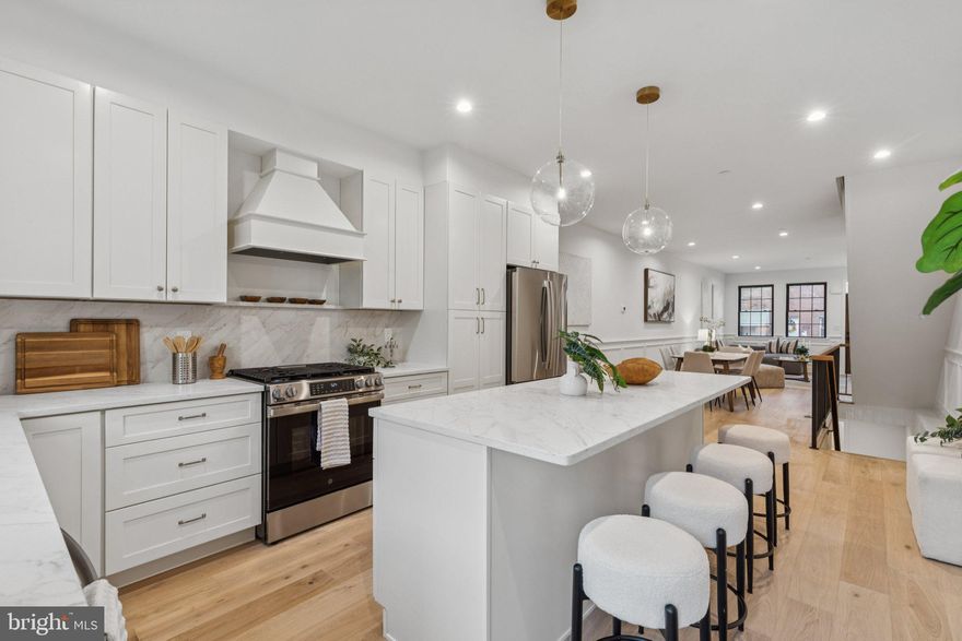 Welcome to 2016 Morris St, a stunning 2,600 sq. ft. custom-built property located in the heart of Point Breeze. This 3-bedroom, 4-bathroom new construction offers unparalleled craftsmanship and luxurious living, with convenient access to Center City, Rittenhouse Square, and I-76. Step inside to find an open-concept living area featuring engineered hardwood floors and a gourmet kitchen with custom cabinetry, a spacious island, and stainless steel GE appliances. The backyard is perfect for entertaining, complete with a barbecue grill, artificial grass, and ample space for outdoor furniture. On the second floor, you’ll find a large guest bedroom with an en suite bathroom, a massive walk-in laundry room with overhead cabinetry, an additional hallway bathroom, and a spacious bedroom at the end of the hall. The master suite boasts a deluxe bedroom with a huge walk-through closet featuring built-in shelving, and a spa-like bathroom with a double vanity and a large glass-enclosed shower. Just outside the master bedroom, enjoy the front balcony or the large rooftop deck, which offers a breathtaking city skyline and panoramic views of the city, stadiums, and bridges. The finished basement includes a full bathroom and space for an optional fourth bedroom or office. This property also comes with a 10-year tax abatement and a 1-year builder’s warranty. Don’t miss this unique opportunity to own a luxury home in the vibrant Point Breeze neighborhood