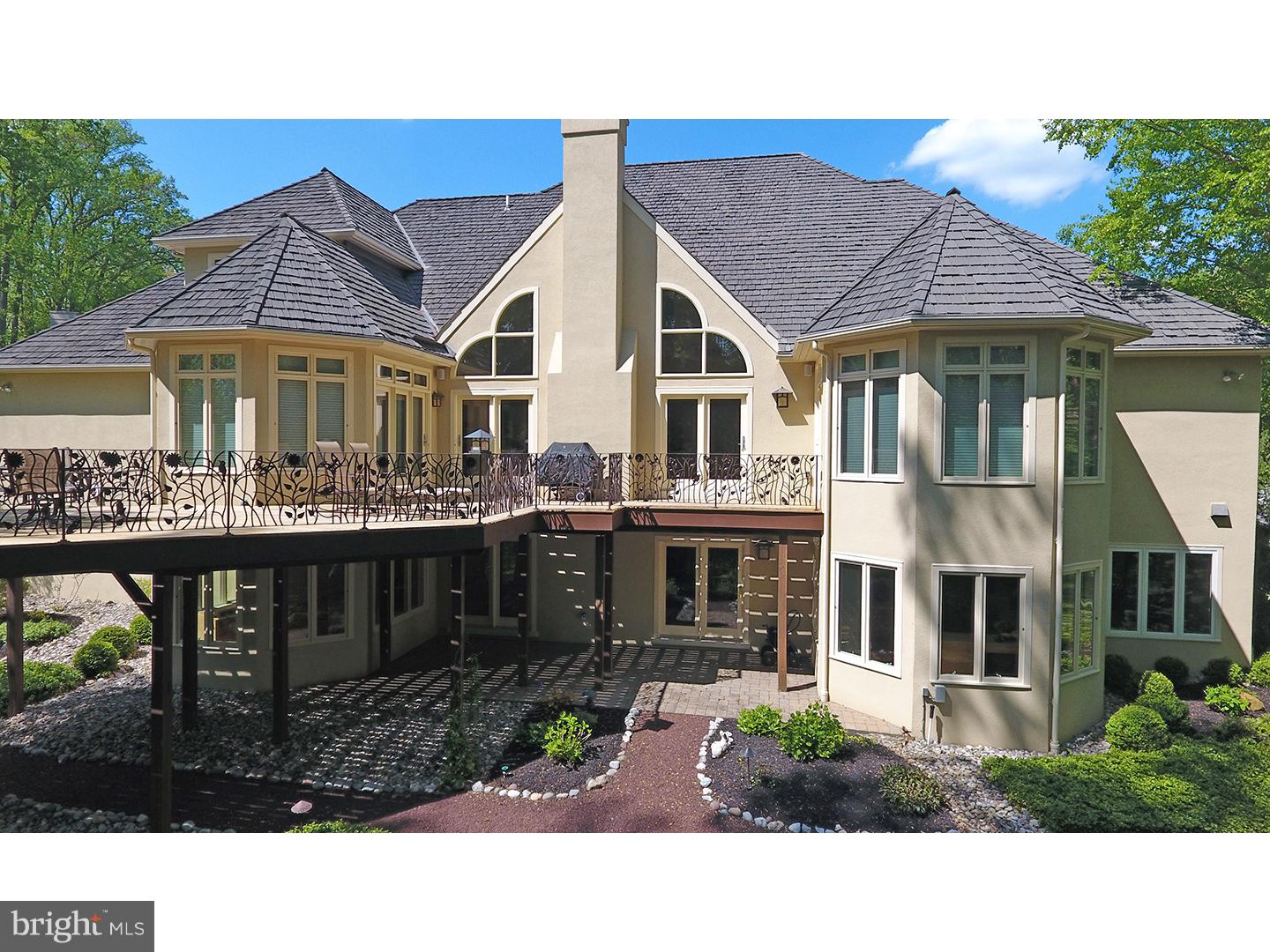 This exceptional transitional property offers the highest quality of design and craftsmanship coupled with today's modern amenities. From the moment you enter the driveway, you will note many special details, from the bucolic landscaping to the magnificent oak custom built front door. Step inside and admire the soaring foyer and gracious stairway with custom wood railing design. Beyond the foyer, you'll find a formal dining room with recessed lighting and an adjacent butler pantry. The sun filled great room offers a dramatic two story ceiling with views of the woodland beyond, and an overlooking balcony above. There are beautiful quarter sawn maple floors and a wall of exquisite wood cabinetry, glass & granite. The kitchen features sleek wood cabinetry, granite counter tops and back splash, two sinks, a Sub-Zero refrigerator, under counter lighting, Miele dishwasher, Thermador double ovens and Thermador cook top. Enjoy a first-floor master suite with serene sitting area and French doors to the rear wrap around deck. The master bedroom offers vaulted ceilings, recessed lighting, his/her walk-in closets with organizers and newly remodeled his/her bathrooms complete with radiant heat flooring. Upstairs, find three more bedrooms, each with its own en suite bathroom. A large walk-in cedar closet adds lots of extra storage. The full walkout lower level has floor-to-ceiling windows on the entire rear portion of the home. There is a dedicated office, exercise area, in-home theater, laundry room with laundry chute and tons of storage. Front and rear staircases offer access to the second level. The lower level has a staircase from the first level foyer, and also a staircase from the garage directly to the lower level. This modern, sunlit home backs up to a private open landscape of conserved land for resort like views all year round! Walk to school, park and town location in an exceptional township and award winning school district. Don't miss this opportunity to tour!