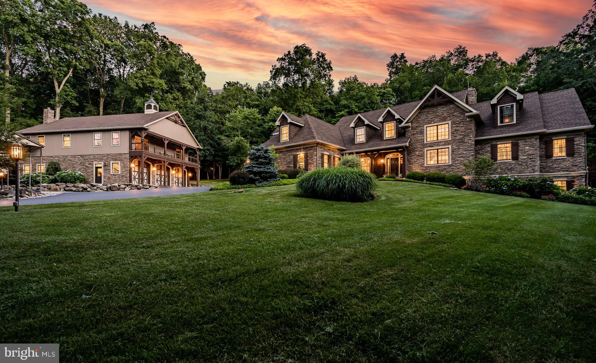 Welcome to your luxury mountain retreat right here in the heart of Chester County, offering 27.5 acres of privacy and stunning craftsmanship and mechanicals throughout. The main house has a wide-open floor plan with a first floor primary suite. Lots of windows, a two story living area, and the second floor loft let light flow through this home. The main living area features a two story living room that opens to the kitchen and dining rooms and is anchored by a beautiful stone fireplace. The kitchen has all the bells and whistles, including a Sub-Zero refrigerator/freezer, 6 burner Wolfe cooktop and range with griddle, Wolfe double wall ovens, a Miele dishwasher, a wine cooler and a Sub-Zero ice maker. An oversized island is the perfect gathering place for all your entertaining needs. The first floor primary suite has every detail covered. There’s a gas fireplace, double walk-in closets (by Closets By Design), and a patio off the bedroom. The primary bath has radiant hot water heated floors, a soaking tub and separate walk-in shower, as well extensive granite, woodwork and cabinetry. A generous first floor laundry/storage room, full hall bath and access to the 2 car garage round out the first floor. The second floor is accessed by front or rear staircases and has a big open loft area overlooking the living area. There’s a craft room, 2 bedrooms and a full bath as well as deck access from the loft. There’s enough space to easily add another bedroom or two in the loft area.
A walkout daylight basement affords plenty of options for storage, a home gym, or another bedroom and bathroom (plumbing is already roughed in) as well as a glimpse into the superior construction and mechanicals of this home. Please ask for the features sheet for more information.
The detached oversized garage has an amazing finished entertainment area with a vaulted ceiling and a full bath and bedroom plus a full kitchen with a wine cooler - use it as another residence, or for the ultimate place to watch the big game. A wrap-around deck is the icing on the cake. You’ve got to see this in person to grasp how awesome this area is.
The 3+ car garage below has a workshop area, a game processing or storage room, and an outdoor shower.
Extensive landscaping, decks, hot tub, a patio, a fire pit area and a retractable awning highlight this home.
This home is truly stunning and an outdoor person's dream. There are quad trails, a 'carport' for your boat or RV, a deluxe enclosed hunting blind or tree house and too many other features to list.
All this is at the end of a cul-de-sac neighborhood just minutes away from major routes, shopping, and restaurants, yet you’ll feel miles away from the outside world. Want even more land? There’s an opportunity to purchase a contiguous 9.8 acre lot if desired - ask for details.
