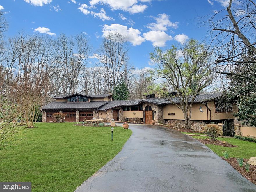 This custom built  6254 sqft 7 BR, 6 BA, 2 HBA home is located at the end of a private road and sited on a beautiful 2.57 acre lot with a pool, terraced patios, gated circular driveway, and 3 car garage.  The residence features multiple vaulted red cedar paneled ceilings and connection with nature through floor-to-ceiling windows and sliding doors that allow light to enter rooms from multiple angles.

 The split-level foyer with a custom-designed double front door opens up to a unique layout with plenty of open yet separate spaces excellent for entertaining as well everyday living. Surrounded by mature trees and lush landscape, multiple water features, a pool with new heater, built-in gas grill and extensive triple-tiered patio spaces with custom built-in bench seating in multiple picturesque locations all add to the resort-like and design-centric appeal.

 The kitchen has granite counters, two paneled bosch dishwashers, and a paneled sub zero fridge and two wall ovens. The family room’s architectural cylindric fireplace and custom built-ins integrate seamlessly with treed window views as well as with the interior’s artistic, geometric lines and fantastic vaulted red cedar ceilings. The living room is floored with mahogany and oak hardwoods.

The primary bedroom is a main level suite that includes private views of a stunning mature magnolia tree, and walk-in-closet. The spa-like bath features dual vanities, and a large, beautifully tiled steam shower with bench.

 4 more secondary bedrooms with custom built-ins on their own level continue the theme of bringing the outdoors in with almost full wall windows on almost every exposure. Both the upper and lower levels offer a powder room.

 Dual staircases are a clever floorplan choice, lending access to the expansive walk-out lower level whilst maximizing the residence’s wide footprint.  Both a family entrance stairwell (with garage access) and a formal entrance stairwell lead to the lower level’s offerings: sixth and seventh bedrooms, a laundry room, great room, recreation room, and bonus catering area, ideal for au-pair or catering needs. The great room and recreation rooms’ exterior doors lead to the rear terraces and entertaining spaces.

A generator, landscape lighting, separate pool storage and programmable irrigation add to the amenities and to the home’s year-round appeal.