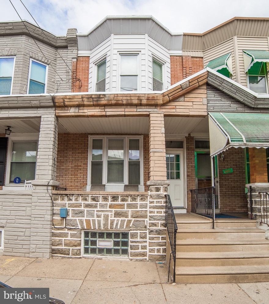 Welcome to this charming straightthru in Port Richmond. You'll first notice the front covered porch and stone/brick front. You walk into a vestibule that opens into the living room. The original wood floors run throughout the entire house. Through the living and dining rooms is the kitchen, which includes built-in microwave, double sink, new electric range/stove top, and new refrigerator. Just through the kitchen is a rear laundry room and entry to the rear patio. Upstairs you'll find three bedrooms and a full bathroom. The full basement is partially finished as has a convenient half bath. The central air system was installed in 2015. Many of the windows are new and the entire house was rewired with brand new electrical wiring and outlets, etc. The front and back doors are new as well and the roof has recent silver coating. This house is move-in ready.