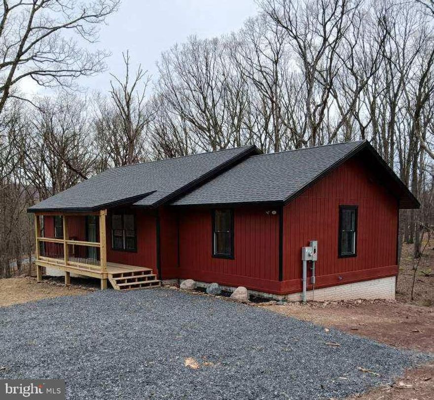 River Ridge, the Cacapon River's premier river access community offering secure access, paved roads, a well appointed river park with bath house facilities, picnic area and boat storage,  Now let's put a brand new, well constructed ranch style cabin on 3.34 Acres in the picture! 3 bedrooms, 2 full baths, central air and heat. Spacious open layout with large window in every room allowing in the natural light. High cathedral ceilings in natural pine plank. Custom multi stage finishes through the home with a rustic theme giving a warm country feel. The kitchen has stunning white granite countertops and a center island with a butcher-block surface, New stainless appliances. The bathrooms have beautiful tile work and deep tubs. Covered front porch and rear deck made just right for relaxing outdoors. The lower level is ready to be finished with windows and doors in place. You'll find the full bath & laundry already ruff plumbed and partitioned, also plenty of room for the family room and an extra bedroom or two. Best of all these are mostly framed up now. With the lower level completed 2,600 of living space is yours to enjoy. All this and more just a short distance from Berkeley Springs with its Spas, Arts, Shopping and Entertainment.  You wont want to miss this one, give us a call today!