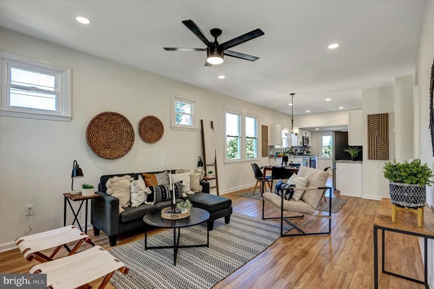 Beautifully renovated 3BR/2BA Cottage located on a spacious lot in a desirable neighborhood. Pull into the extra long driveway flanked by adult shade trees and make your way to the front door into your forever home.  Step into an enclosed front porch offering tons of natural light and an ideal space for a home office.  The main floor offers recessed lighting, wood flooring throughout the open floor plan featuring a spacious living room, dining room, and amazing kitchen.  The kitchen boasts plenty of cabinets, stainless steel appliances, granite countertops with a complimenting tiled backsplash, and a deep sink under a window.  On the main floor are two primary sized bedrooms and a newly renovated full bath.  The lower level offers additional living space featuring the third bedroom, a full bath with a tiled walk-in shower, space for the family to gather, laundry, storage, and a walk-out to the amazing yard space.  From the kitchen step outside to an oversized wood deck that overlooks the tons of green space and adult trees in the yard.  This home is move-in ready with so much to offer new homeowners and is located in close proximity to shopping, restaurants, and commuter routes.