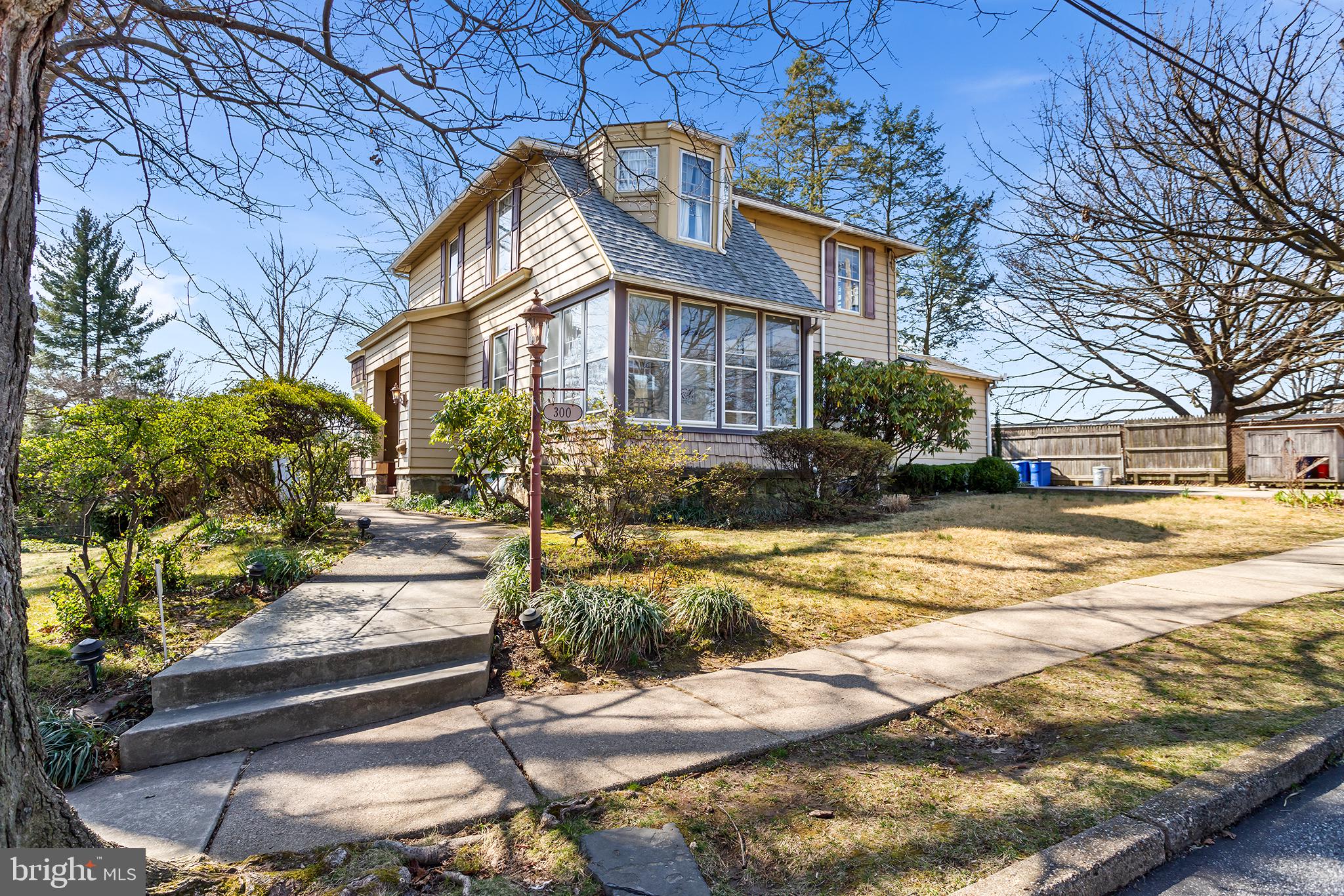 Opportunity awaits at this stunning Victorian with 3,200 square ft overlooking Ridley Park Lake. This 4 bedroom, 2 ½ bathroom home has tons of space to spread out or entertain, or find yourself a nook to cozy up in. Hardwood floors stretch throughout the entire house, providing elegance and durability. A huge great room sits the entire length of one side of the house highlighted by exposed beams, a striking stone fireplace, built-ins, bench seats, and oversized windows.  This truly is the focal point of the home. A formal dining room with French doors leads to a three-season sun porch, allowing for seamless indoor-outdoor flow and plenty of natural light. An open kitchen with an eat-in area and wide plank hardwood floors is perfect for casual dining. The convenient first floor laundry can also be found here. Adjacent to this space is a huge mudroom, providing convenience and ample storage space, with an outside exit to a paver patio and lovely rear yard. On the second floor, there is a main bedroom with generous closet space, offering comfort and privacy. Additionally, there are three more bedrooms with hardwood floors and an abundance of natural light. 2 full bathrooms complete this level. This home offers a blend of spaciousness, charm, and beauty, making it an inviting retreat overlooking the serene Ridley Park Lake with the perfect view of the 4th of July fireworks! Located in the Ridley school district, less than 10 minutes to the Philadelphia International airport, and 20-30 minutes to the cities of Philadelphia or Wilmington, DE. Close Proximity to I95 and public transportation. Close to many shops and restaurants of Ridley Park and surrounding towns.