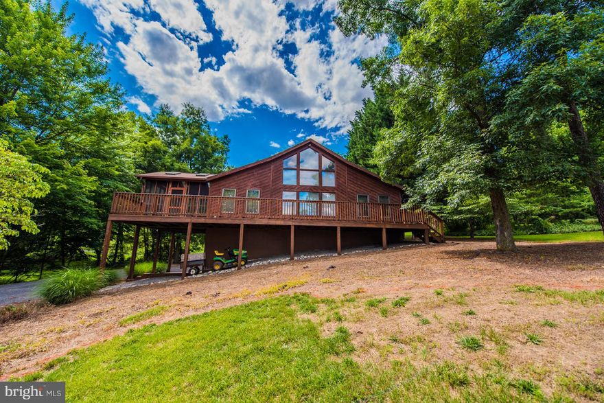 Like new, move in ready! Choose your lifestyle.  Whether you are looking for a full time home or a weekend getaway, this home will meet all your needs.  Chestnut style home located in The Woods Resort, boasts a spacious open floor plan w/ a sunken living room with a wood stove for those cool fall/winter evenings.  Newly remodeled kitchen with granite counter tops and new flooring throughout. 3 bedrooms and 2 baths on the main level with an upper level loft. Basement features a Family Room improved w/ insulated walls, just ready for drywall. partitioned walls for laundry and 3rd bath as well as a 2-car garage,  Screened deck, new open deck in front of home, and freshly painted covered back porch offer multiple locations for outdoor entertaining.  Views of #4 green & par 3,#11. Class A Full golf membership available.