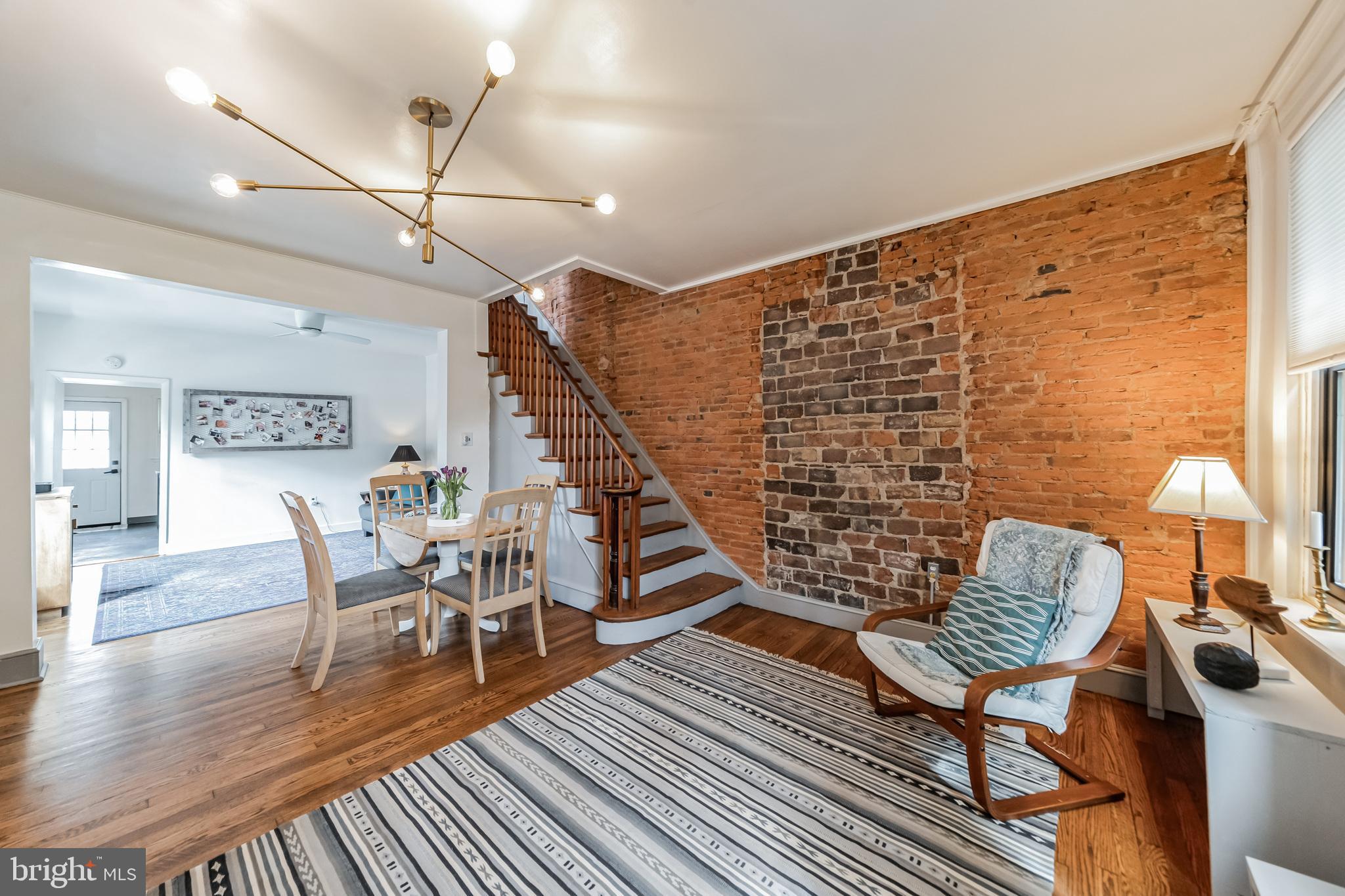 Stunning Fishtown Corner Row Home!
Located in the vibrant heart of Fishtown, this incredible three-story home sits on a coveted corner lot and comes with a private one-car garage—an absolute must-see! From the moment you venture inside, you'll be captivated by the seamless blend of historic charm and modern updates.
Spanning nearly 1,700 square feet, the home welcomes you with a cozy front living space featuring original hardwood floors, exposed brick walls, and a beautifully preserved wood staircase. This area flows effortlessly into a secondary living or dining space, bathed in natural light from oversized windows. The kitchen is both functional and inviting, offering ample cabinet and counter space, a central island for casual dining, and two large windows that enhance the bright, airy atmosphere. Just outside, a charming patio awaits—perfect for morning coffee or summer grilling.
The second floor hosts two spacious bedrooms and a recently renovated full bathroom. The first bedroom boasts a striking brick accent wall, large windows, and a stylish modern ceiling fan, while the second features vaulted ceilings, abundant natural light, and generous closet space. The contemporary bathroom is a showstopper, with a sleek floating vanity, subway-tiled shower/soaking tub, glass enclosure, and high-end Delta brass fixtures.
On the third floor, you'll find two additional bedrooms. The sun-drenched third bedroom is a dream, complete with three large windows, wood beams, and a lofted nook. The fourth bedroom offers versatility—ideal as a nursery, office, or walk-in closet. The basement provides ample storage and houses the laundry area.
Unbeatable Location!
This prime Fishtown location puts you just blocks away from the best of the neighborhood. Stroll along Frankford Avenue to explore its renowned shops and restaurants, or head toward the river to enjoy the scenic beauty of Penn Treaty Park. Experience the lively energy of the area while still enjoying a warm, small-town feel.
Don’t miss out on this incredible home—schedule your showing today!