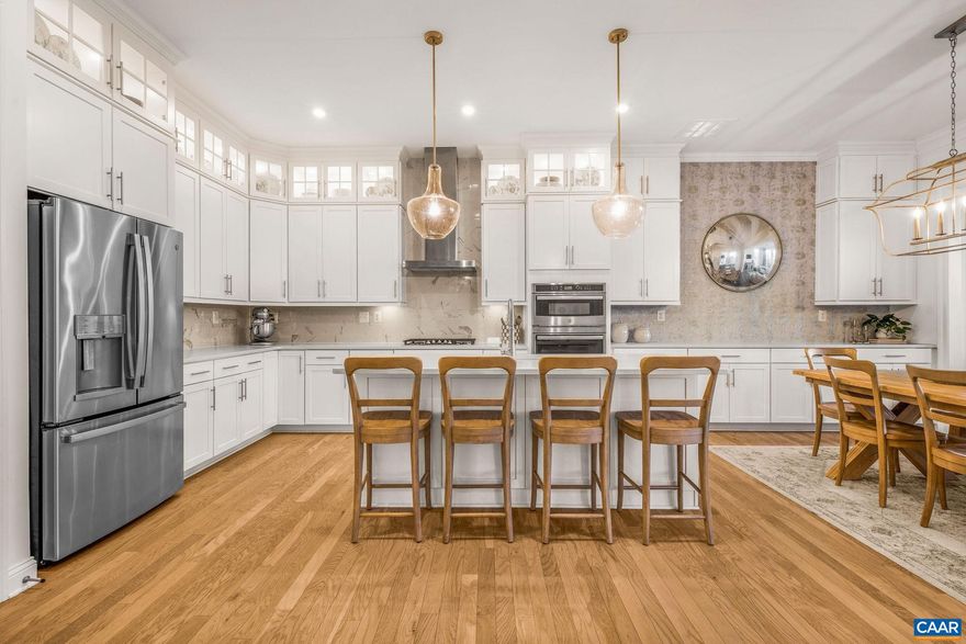 Located in sought after Glenmore, this beautifully appointed five-bedroom, three-and-a-half-bath home, built just five years ago, offers refined one-level living with a finished basement and a thoughtfully designed, light-filled layout. The main level showcases an upgraded kitchen with generous island seating, quality cabinetry, quartz countertops, and carefully selected fixtures, all opening seamlessly to the dining and living spaces. Clean lines, tasteful wallpaper, and expansive windows create a cohesive, airy feel throughout the home. Three bedrooms, including a well-appointed primary suite, are conveniently located on the main level. The finished basement continues the home?s high standard of design, featuring an additional bedroom and full bath, a spacious family room, dedicated home office/5th bedroom, and gym?each space finished with the same attention to detail found on the main level. An ideal 3 car garage leaves plenty of room for cars and storage.  A thoughtfully designed home offering comfort, flexibility, and an exceptional Glenmore location directly across from a large park and connected to tranquil walking trails. The purchaser of this home qualifies for a 25% discount on initiation to the Club at Glenmore.,White Cabinets,Fireplace in Family Room