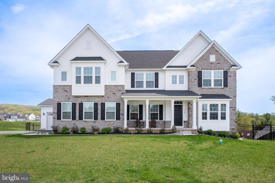 Stunning custom home in SAUCON VALLEY ESTATES is the perfect blend of contemporary sophistication and THOUGHTFUL DESIGN. Built in 2023, this home offers SUN-DRENCHED spaces, soaring ceilings, WOOD FLOORS and impeccable finishes. The OPEN FLOOR PLAN connects the formal dining room to the expansive GREAT ROOM, which boasts a GAS FIREPLACE with a stunning granite surround and a custom wood mantel. The heart of the home is the GOURMET KITCHEN featuring quartz countertops, a large CENTER ISLAND, walk-in pantry, high-end GE Profile stainless steel appliances, a 6-BURNER GAS RANGE with griddle, and a HERRINGBONE TILE backsplash. This home was designed with convenience in mind, offering a coveted FIRST-FLOOR BEDROOM with a private ensuite, ideal for guests. Upstairs, FOUR ADDITIONAL BEDROOMS await, including the breathtaking primary suite with a spa-like bathroom with an oversized glass-enclosed shower and dual vanities. The lower level offers a versatile recreation room with WALK-OUT, exercise room/GYM, private OFFICE (or 6th bedroom) and additional FULL BATH. Step outside to your exquisite BRAND-NEW SALT WATER swimming pool, ready for sun-soaked summer days plus a Trex DECK, covered patio, 3 CAR GARAGE and a beautifully landscaped, FENCED-IN YARD. With its premier location in Center Valley and Southern Lehigh School District, this is the perfect place to call home!