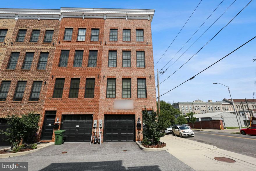 Gorgeous 4 level end unit with garage! This amazing home was built in 2018. Open floor plan with white kitchen, granite counters, island, stainless steel appliances, double oven, gas cooktop with exhaust hood. Large dining area, living room and half bath on this level. Primary bedroom on third level with en suite bath with double vanity and stand up shower. Additional bedroom and hall bath on this level. Fourth level boasts an additional bedroom with en suite bath, wet bar with wine fridge and family room area. Sliders to lower deck and roof top deck with spectacular views of Baltimore! Oversized 3 car garage.  Located in Hampstead Hill school district.