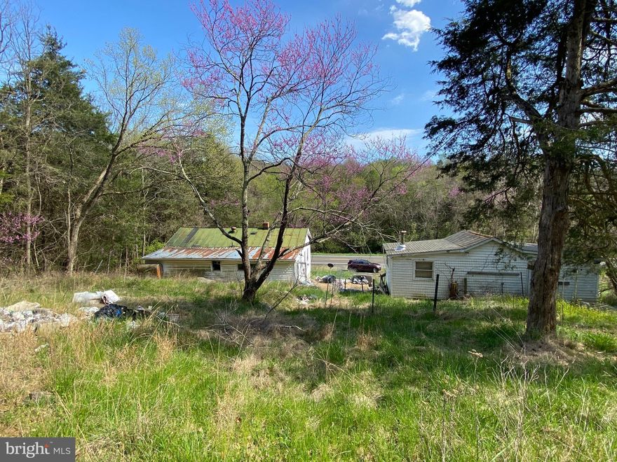 Investor special in Bentonville on a high visible artery with tons of upside!  House is burned out but knock it down and put something up that makes you income!  Property has cistern and on site septic (No documents found a health department for septic).  Bring offers!