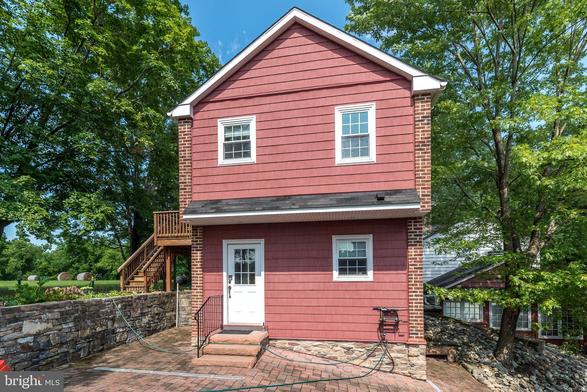 Welcome to the Carriage house at 2478 River Rd, a charming rental opportunity nestled on a picturesque historic farm just outside New Hope, Pennsylvania. This unique property offers a serene living environment with the convenience of being less than a mile from the vibrant downtown area, known for its eclectic shopping and dining experiences. This carriage house features an open New York studio-style living room and kitchen, providing a spacious and flexible layout. The home is adorned with hardwood floors throughout, enhancing its classic appeal. The heated entry vestibule includes a coat closet, ensuring comfort and practicality upon arrival. The property includes two well-appointed bedrooms and a modern bathroom equipped with a walk-in shower and double sinks, offering both functionality and style.
Residents will appreciate the basement storage, which includes access to a shared washer and dryer. An enclosed garage is available for secure parking. There is also a deck off the side of the home overlooking the spacious yard. Essential utilities such as trash, water, and sewer are included in the rent, providing added convenience. Please note, this property maintains a no pets and no smoking policy to ensure a clean and pleasant living environment for all residents. Landlord requires an excellent credit score, 3 personal or professional references, first and last months rent up front as well as a security deposit. One year lease minimum.