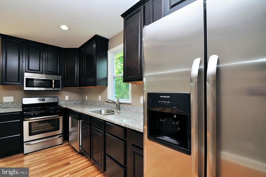 Beautifully renovated 3 bedroom, 2 bath home with practically new everything! New hardwoods in living, dining & kitchen. New stainless appliances, granite counters & beautiful cabinets. Open feel main level. 2 main level bedrooms & upstairs master. Finished lower level & HUGE fenced backyard with new deck. New roof, HVAC, carpet, paint, porch! Close to MARC. PRICE REDUCED.