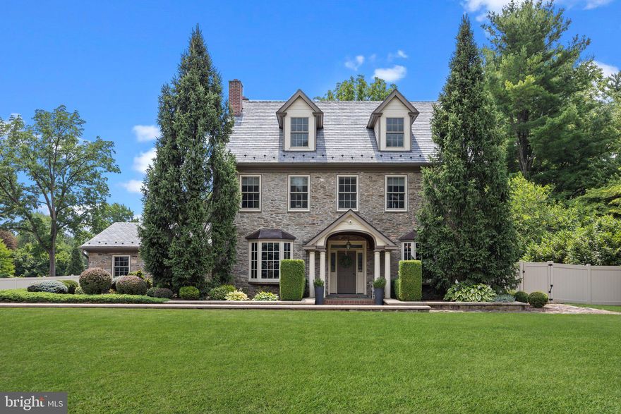 This 18th-century stone Quaker-built home exudes timeless elegance and historical charm. Set back from the road, the property offers a serene retreat. Upon entering, you are greeted by a nice reception hall with original millwork and moldings that highlight the home's rich history. The intricate woodwork, polished to a warm glow, sets the tone for the rest of the house. The main floor features multiple living spaces, each with its own distinctive character. The formal living room, adorned with detailed crown moldings and a stone fireplace, offers a cozy yet sophisticated ambiance. Adjacent to the living room, the study is decorated in wood paneled finishes, and provides a perfect retreat for reading or working from home.
The spacious kitchen combines rustic charm with modern convenience. Custom wood cabinets line the walls and sprawling marble countertops provide any chef delight. The modern appliances are seamlessly integrated, ensuring functionality without compromising the home's historical integrity. Adjoining through the butler’s pantry, the dining room features a large bay window, offering picturesque views of the front grounds. The first thing you notice upon entering the great room addition is the impressive vaulted ceilings. Overhead, substantial wooden beams crisscross the ceiling, adding rustic character and paying homage to the home's historical roots. At the heart of the great room is a grand fireplace, framed by stone and sitting atop it’s hearth is a reclaimed wood mantel, providing a perfect place for displaying cherished items . Large arched windows adorn the walls of the great room, flooding the space with natural light and offering breathtaking views of your rear yard retreat. Discover the unveiled original well that was restored and integrated into the finished design. The home includes four generously sized bedrooms, each with its own unique character. The main quarter features an ensuite bath with a clawfoot tub, a separate shower, and walkthrough dressing area. Also on the second level, is a sun lit bedroom furnished with its own full bath. The penthouse level hosts the two remaining bedrooms that share a generously sized bathroom. In addition, you’ll find a lounge and wellness area. The outdoor area is a true extension of the home’s living space. A well-designed pool area with sun shelf, spa and waterfall, invites relaxation and recreation. The adjacent outdoor kitchen is perfect for entertaining, equipped with appliances and ample counter space. A cozy firepit area, surrounded by comfortable seating, provides an ideal spot for evening gatherings under the stars. Located in the esteemed area of Rydal, where you find upscale shops and eateries, this remarkable home offers a blend of historical craftsmanship and modern luxury, set on a large, private lot with exceptional outdoor amenities. It is a true testament to timeless design and quality.