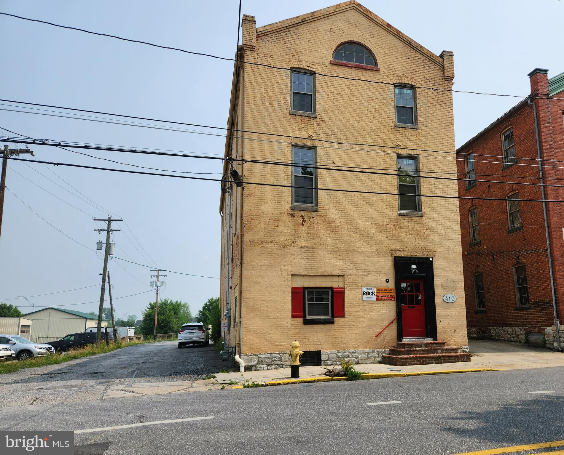 MAJOR PRICE ADJUSTMENT! Multipurpose building in prime location with +/- 6,000 sq. ft. All new HVAC installed Dec 2022 with electric baseboard backup heat. New windows installed 2021, concrete stair fire escape enclosure, and natural gas run to the building. Bathroom on first floor near current office set up, two bathrooms on second floor and on third floor there’s a rough-in ready to finish. Tenant space is private workshop with separate entrance, currently paid a year's lease in advance. Second tenant to rent out office space portion in the front on first floor. So much potential with great exposure.