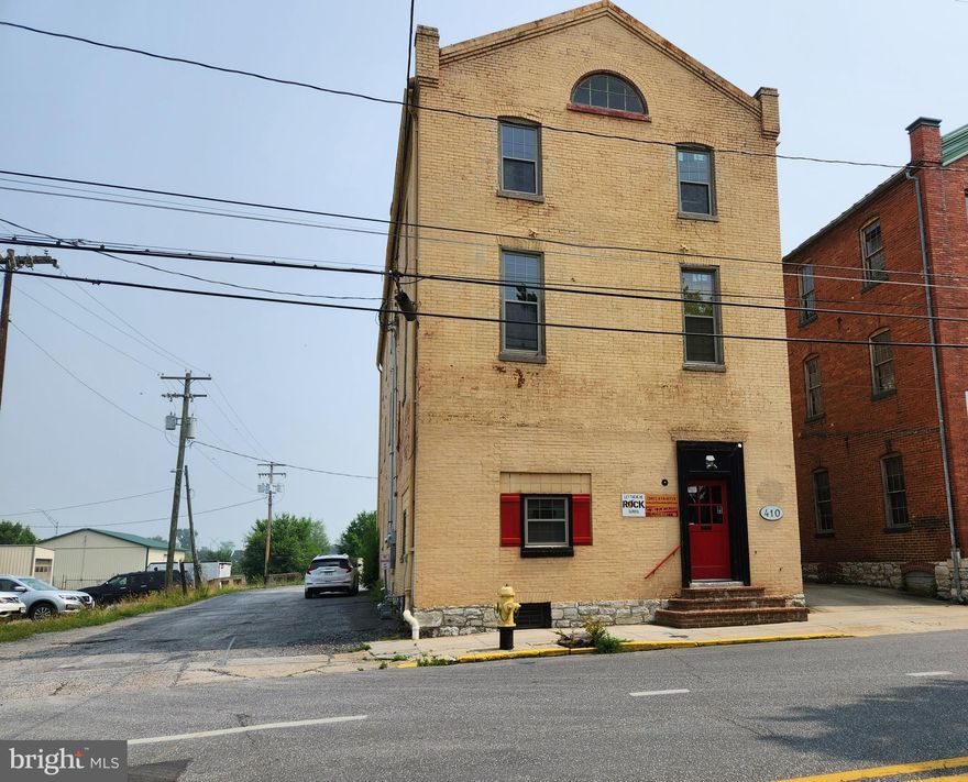 MAJOR PRICE ADJUSTMENT!  Multipurpose building in prime location with +/- 6,000 sq. ft.  All new HVAC installed Dec 2022 with electric baseboard backup heat. New windows installed 2021, concrete stair fire escape enclosure, and natural gas run to the building.  Bathroom on first floor near current office set up, two bathrooms on second floor and on third floor there’s a rough-in ready to finish. Tenant space is private workshop with separate entrance, currently paid a year's lease in advance. Second tenant to rent out office space portion in the front on first floor. So much potential with great exposure.