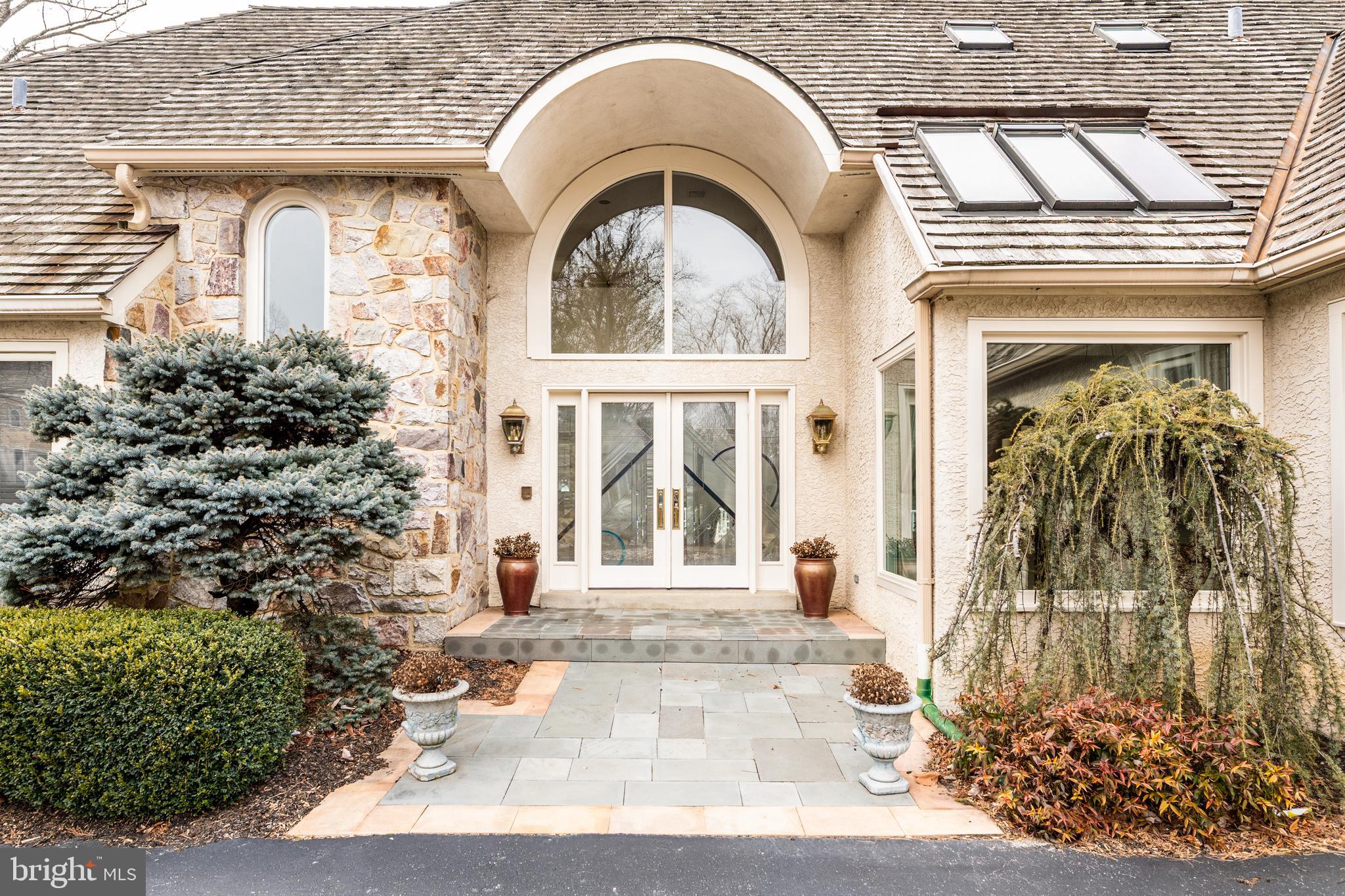 246 Maple Hill Road, a sophisticated home positioned on a private lane, minutes
from Gladwyne Town Center, offers 3585 square feet of beautifully designed living space and
2000 square feet of additional space on the lower level. Drive down the private road onto the
cul-de-sac and enter the circular driveway to see how this home offers the perfect blend of
tranquility, accessibility and plenty of natural sunlight. Step inside and be greeted by an inviting
two- story foyer. Straight ahead is the living room featuring a dramatic two story ceiling, a wood burning fireplace, and French doors spanning the width of the room. The dining room is
positioned near the den which features large glass doors and a fireplace. Access to
the expansive rear deck from either room seamlessly blends indoor and outdoor living space.
The newer kitchen is a chef’s delight and features custom cabinetry, a large center island and
breakfast bar, a large pantry, Sub-Zero refrigerator, Wolf wall oven, microwave, cooktop and wine cooler. The breakfast room features a vaulted ceiling with sky lights with light coming in from a side window and sliding glass door which also offers access to the deck. The kitchen leads to a large laundry/mud room with half
bath and access to the two-car garage. The owner’s suite is conveniently located on the
opposite side of the first level. The generously sized bedroom offers a vaulted ceiling, recessed
lighting, built in shelving, fireplace and door to rear deck. A newer bath with a designer features
and heated floor, a separate dressing area and walk in custom closet provide comfort and
luxury. A half bath located off the foyer completes this level. The 2 nd level features three bedrooms, the
configuration of which offers maximum flexibility for an in-law or au-pair suite with one
bedroom having an en-suite bath. The additional two bedrooms share a full bath. The finished
lower level provides another level of living, highlighted by a large family/playroom, a fitness
room, an office and full bath. Professional landscaping ,including an irrigation system ,and serene surroundings create the perfect setting for time at home and entertaining. POSITIVE STUCCO REPORT IS ATTACHED. INCLUDES A FULL HOUSE GENERATOR.