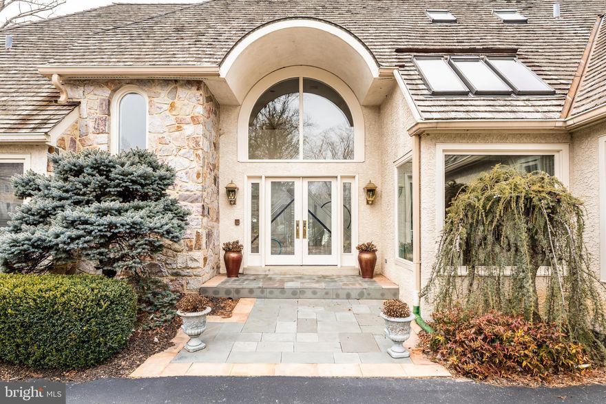 246 Maple Hill Road, a sophisticated home positioned on a private lane, minutes
from Gladwyne Town Center, offers 3585 square feet of beautifully designed living space and
2000 square feet of additional space on the lower level. Drive down the private road onto the
cul-de-sac and enter the circular driveway to see how this home offers the perfect blend of
tranquility, accessibility and plenty of natural sunlight. Step inside and be greeted by an inviting
two- story foyer. Straight ahead is the living room featuring a dramatic two story ceiling, a wood burning fireplace, and French doors spanning the width of the room.  The dining room is
positioned near the den which features large glass doors and a fireplace.  Access to
the expansive rear deck from either room seamlessly blends indoor and outdoor living space.
The newer kitchen is a chef’s delight and features custom cabinetry, a large center island and
breakfast bar, a large pantry, Sub-Zero refrigerator, Wolf wall oven, microwave, cooktop and wine cooler. The breakfast room features a vaulted ceiling with sky lights with light coming in from a side window and sliding glass door which also offers access to the deck. The kitchen leads to a large laundry/mud room with half
bath and access to the two-car garage. The owner’s suite is conveniently located on the
opposite side of the first level. The generously sized bedroom offers a vaulted ceiling, recessed
lighting, built in shelving, fireplace and door to rear deck. A newer bath with a designer features
and heated floor, a separate dressing area and walk in custom closet provide comfort and
luxury. A half bath located off the foyer completes this level. The 2 nd level features three bedrooms, the
configuration of which offers maximum flexibility for an in-law or au-pair suite with one
bedroom having an en-suite bath. The additional two bedrooms share a full bath. The finished
lower level provides another level of living, highlighted by a large family/playroom, a fitness
room, an office and full bath. Professional landscaping ,including an irrigation system ,and serene surroundings create the perfect setting for time at home and entertaining.  POSITIVE STUCCO REPORT IS ATTACHED. INCLUDES A FULL HOUSE GENERATOR.